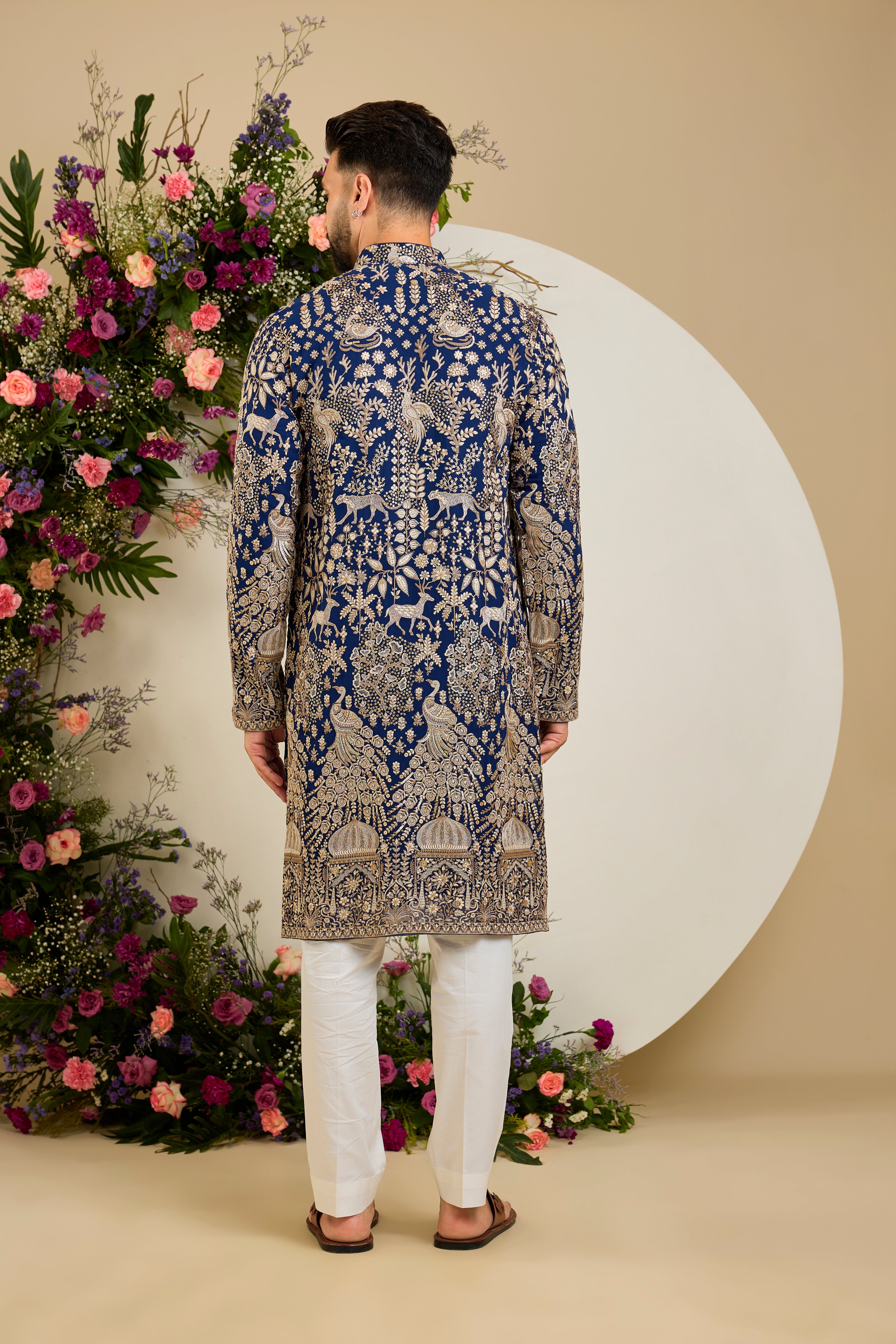 Royal blue heritage   kurta with Mughal domes, peacocks, lions, heavy zari embroidery, and refined sequin detailing.
