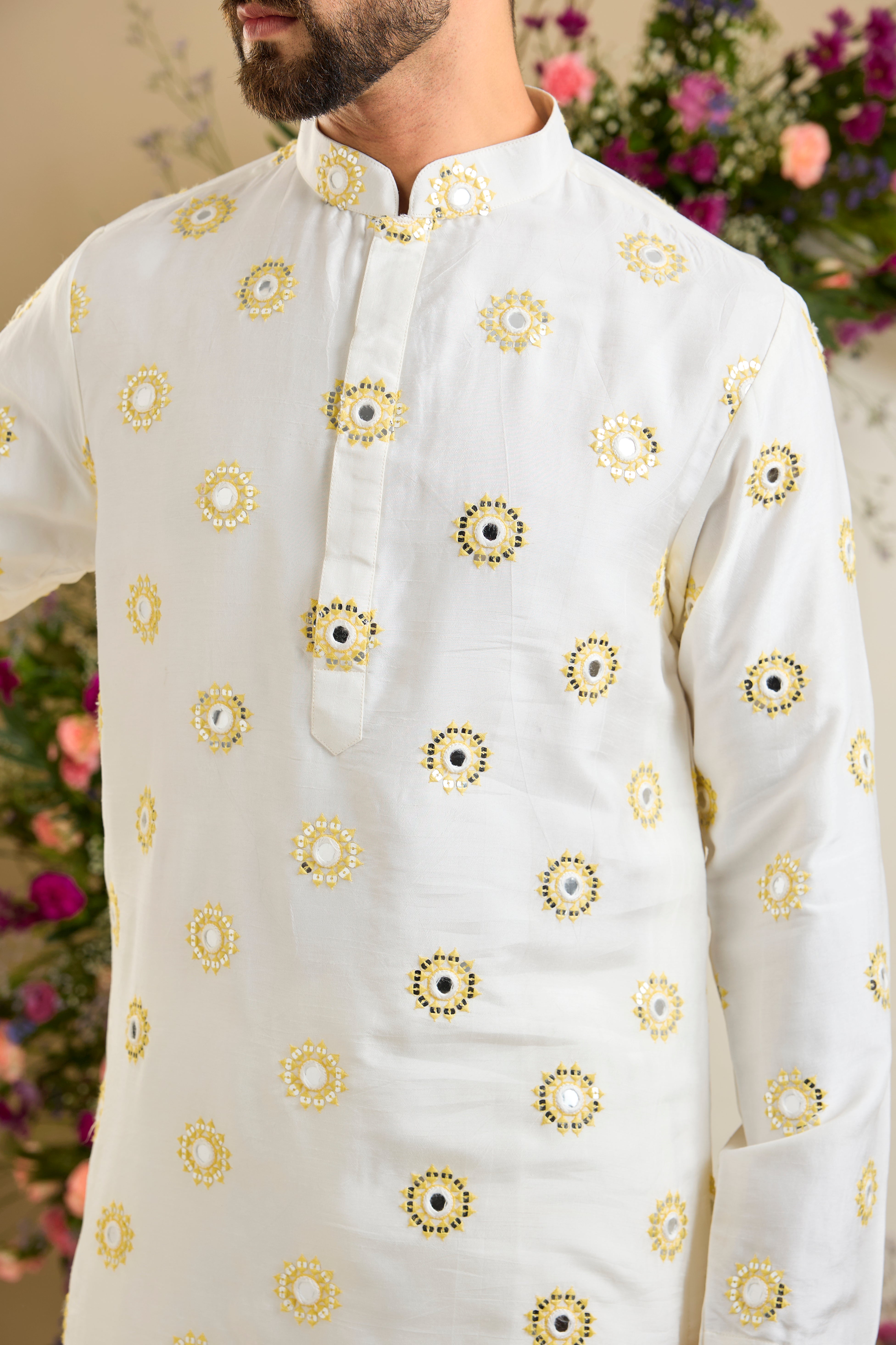 Ivory white mirror work kurta with yellow thread embroidery and delicate sequin detailing for sophisticated occasion wear.