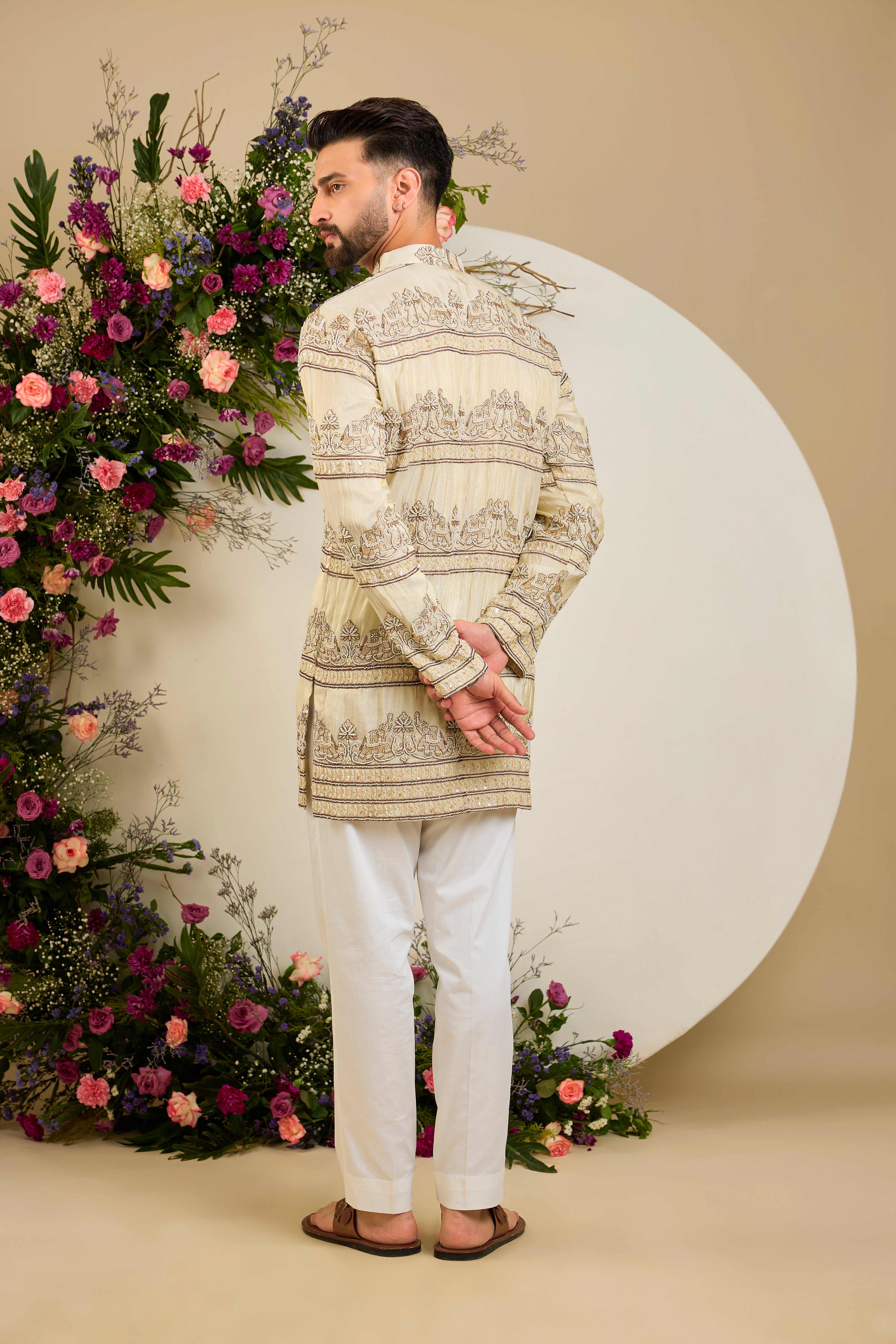 Antique gold tissue kurta with hand-embroidered cut dana work and majestic elephant motifs for grand ceremonial elegance.