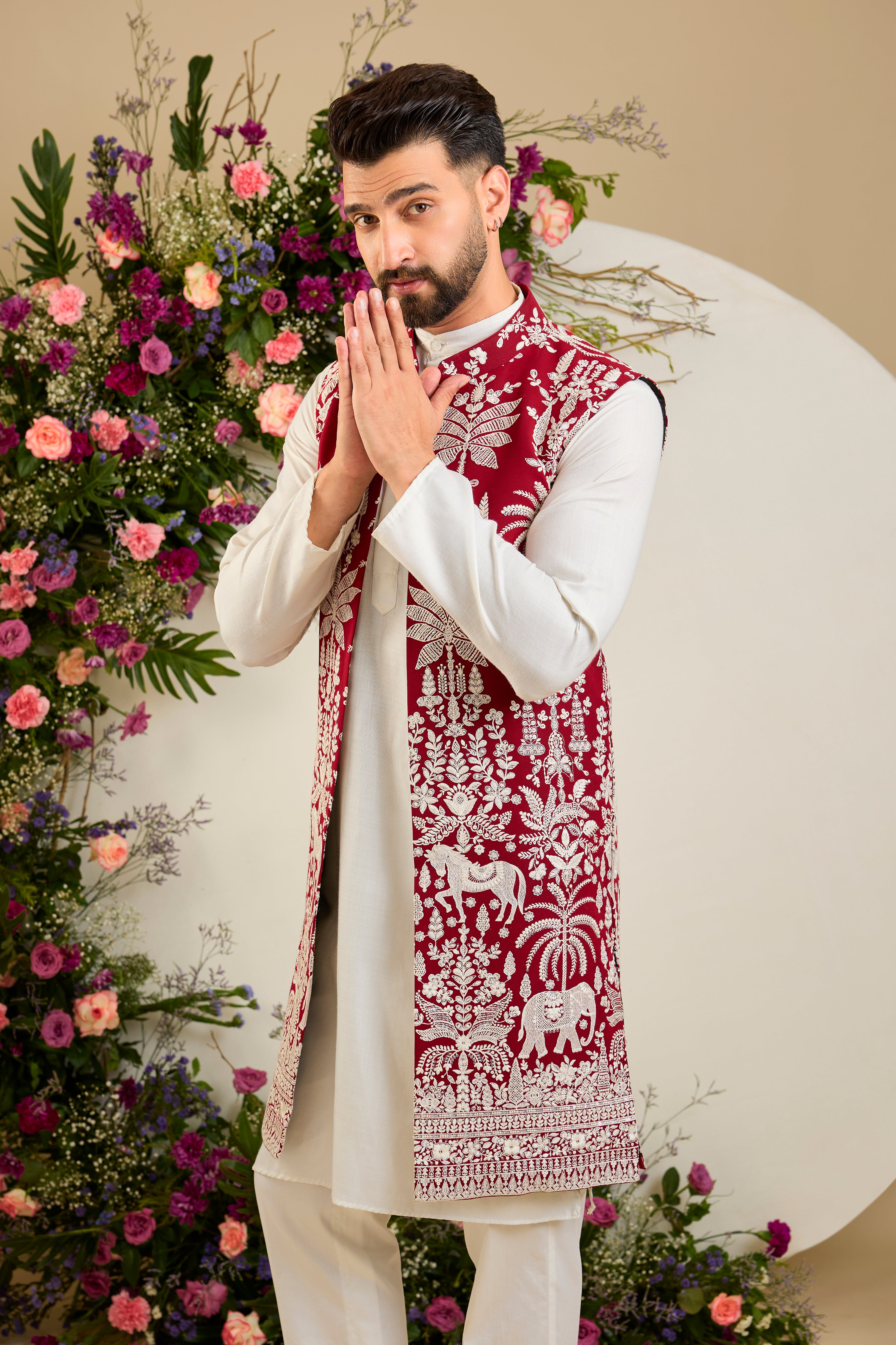 Red long open jacket with tropical flora and fauna embroidery, ivory threadwork, and delicate sequin detailing for refined occasion wear.