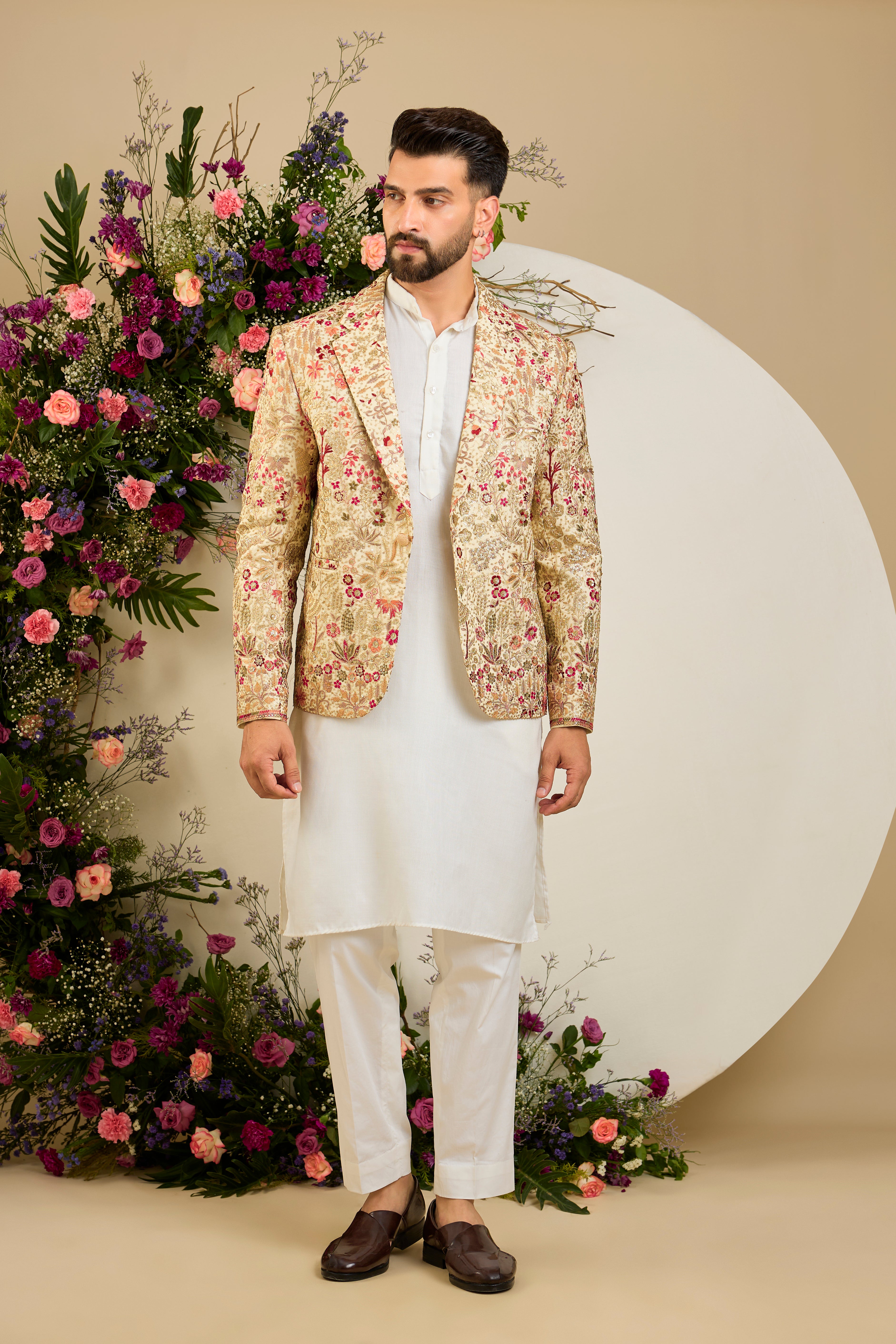 Cream gold blazer with floral embroidery, zari work, multi-coloured thread detailing, and refined sequin embellishments for elevated occasion wear.
