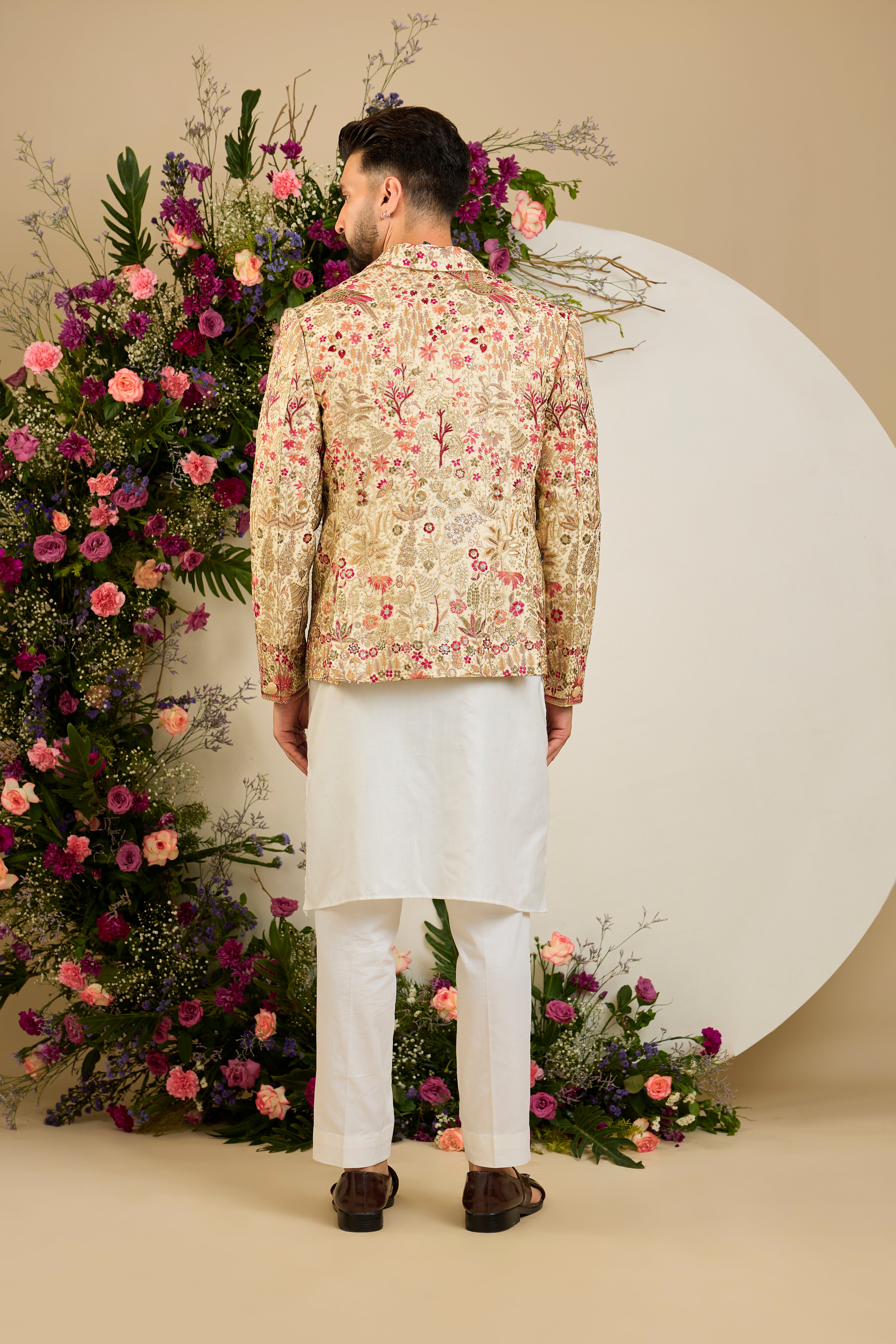 Cream gold blazer with floral embroidery, zari work, multi-coloured thread detailing, and refined sequin embellishments for elevated occasion wear.