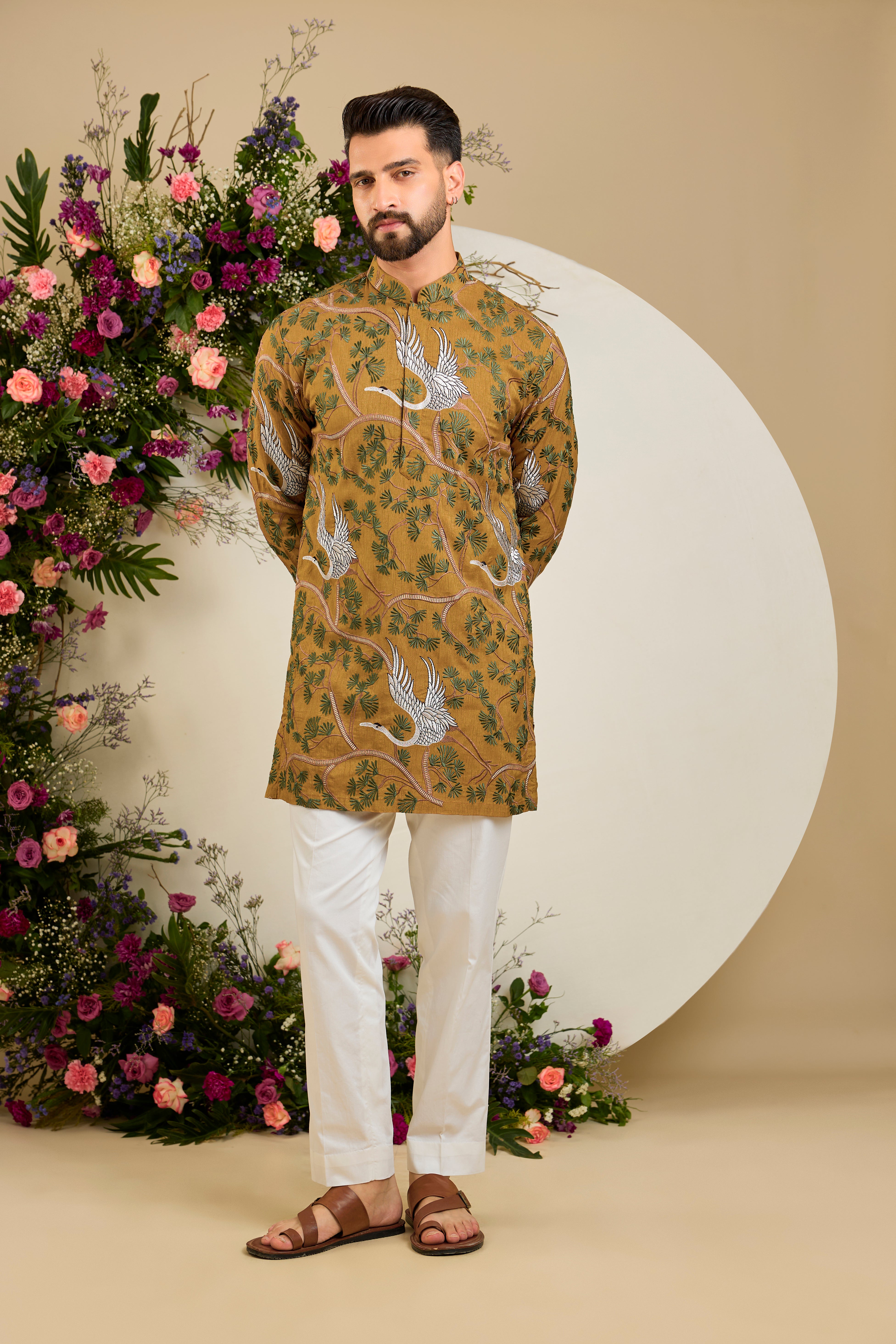 Mustard short kurta with a tropical backdrop, graceful flamingo motifs, intricate threadwork, and delicate sequin embellishments.