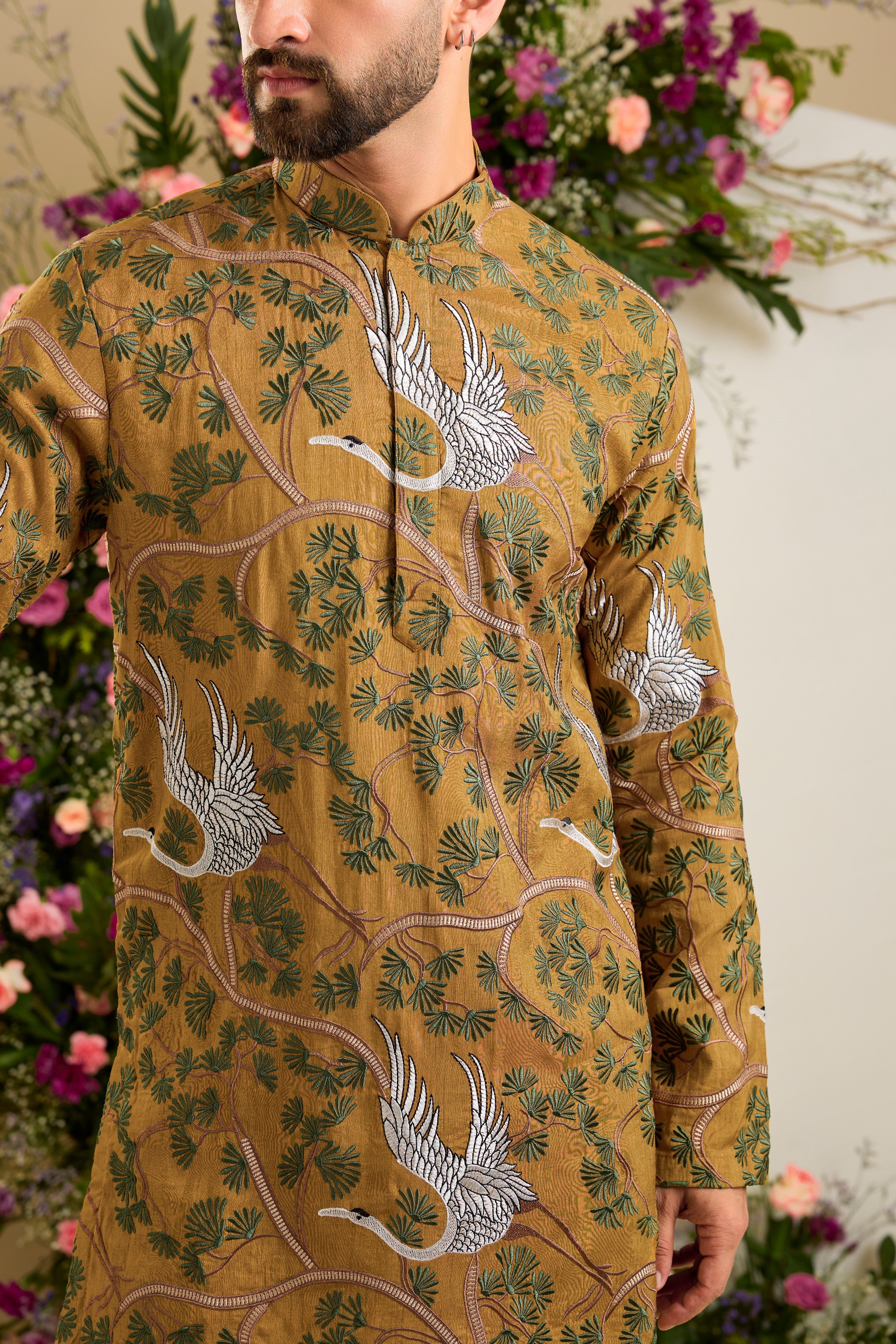 Mustard short kurta with a tropical backdrop, graceful flamingo motifs, intricate threadwork, and delicate sequin embellishments.