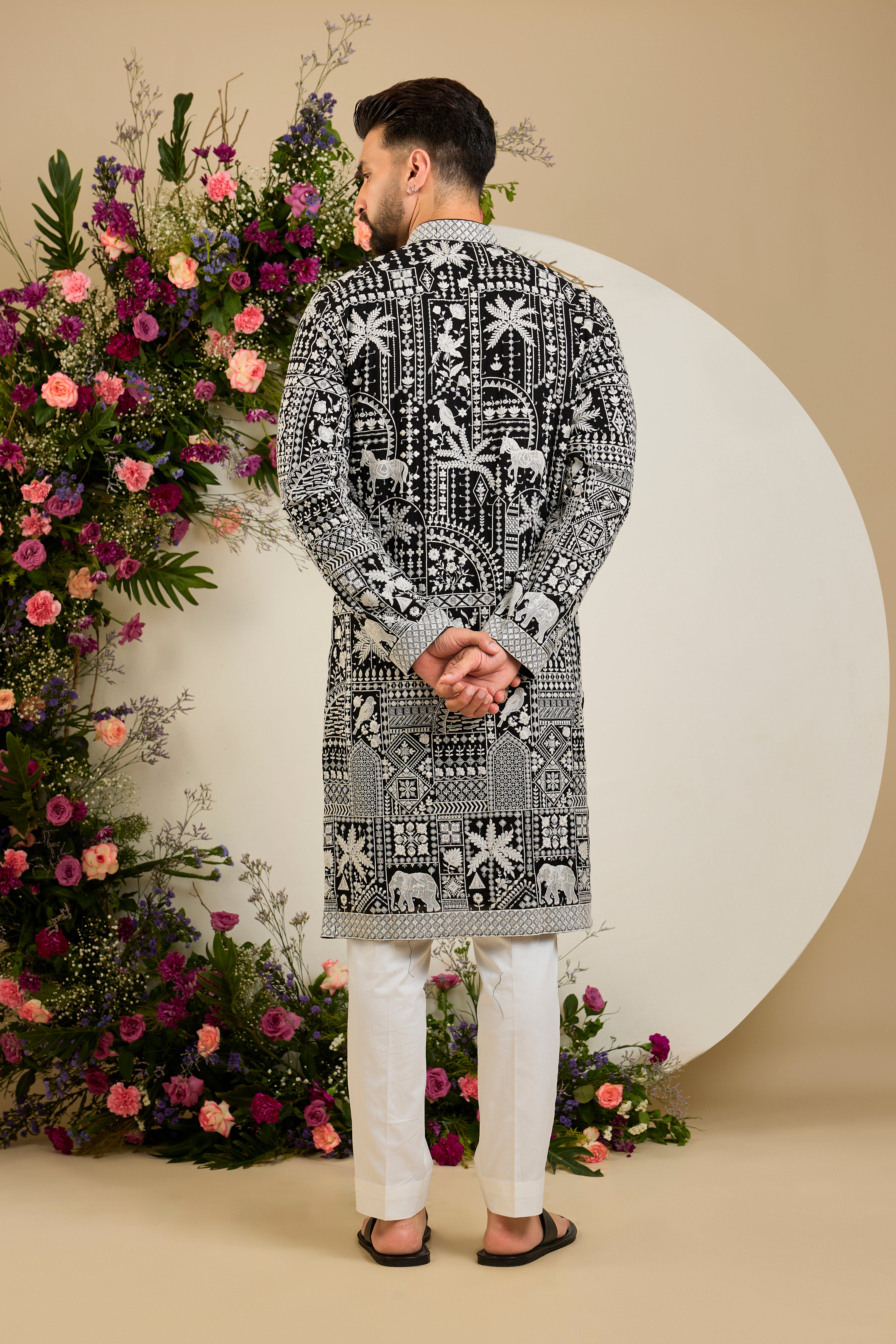 Black kurta with flora and fauna embroidery, an embellished neckline, ivory threadwork, and delicate sequin detailing.