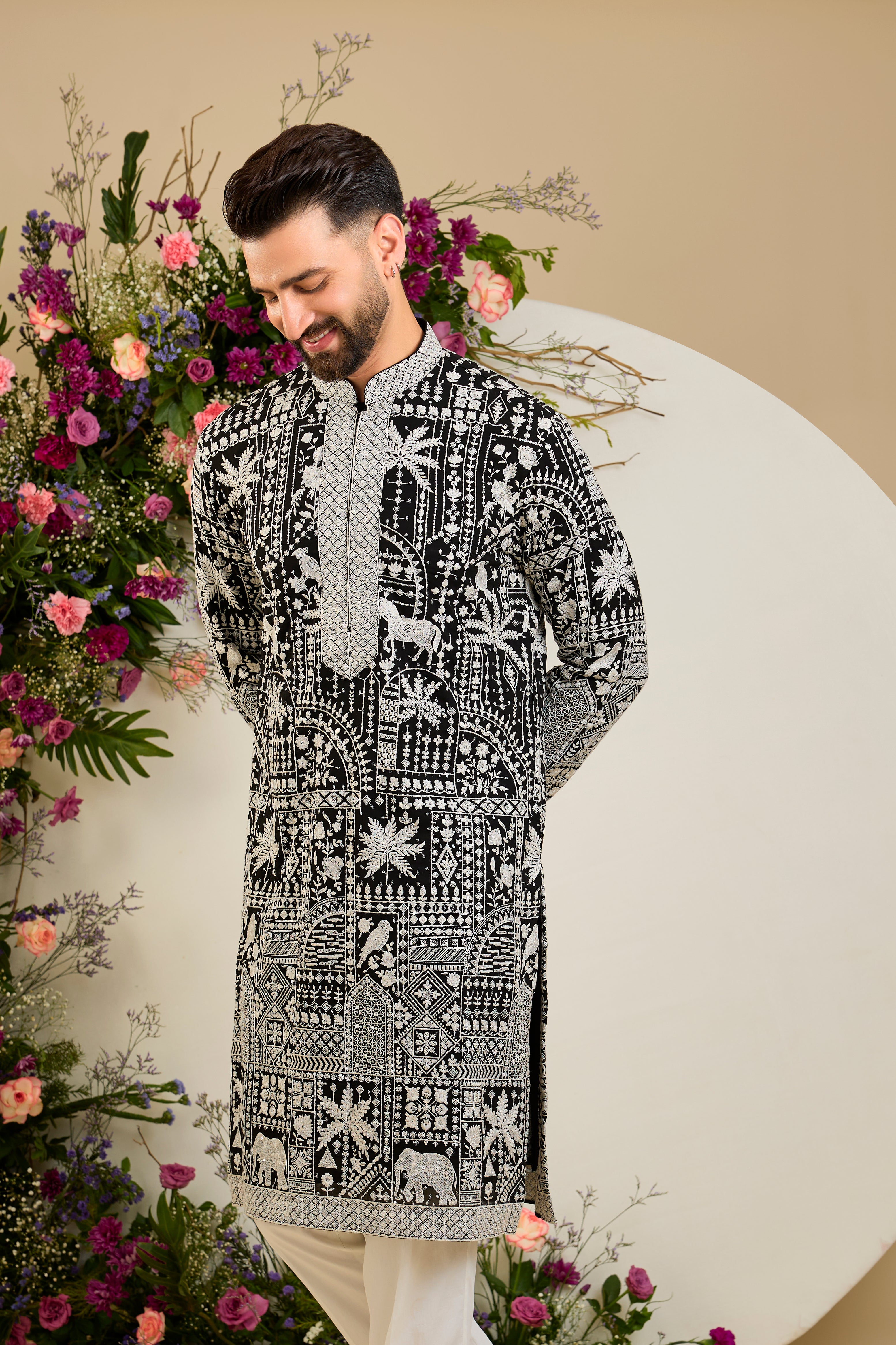 Black kurta with flora and fauna embroidery, an embellished neckline, ivory threadwork, and delicate sequin detailing.