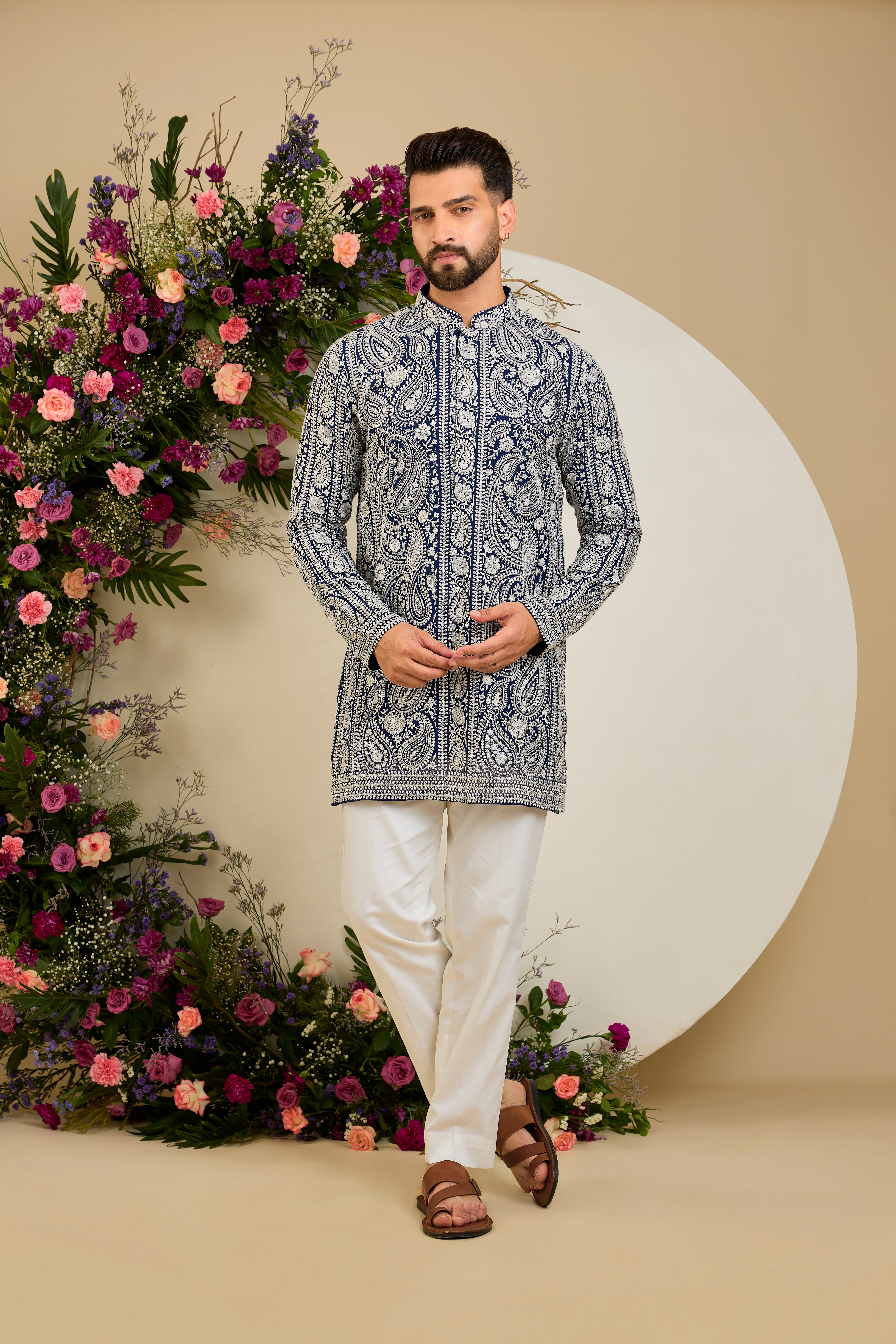 Royal blue short Chikankari kurta with paisley embroidery, ivory and white threadwork, and delicate sequin detailing for timeless elegance.