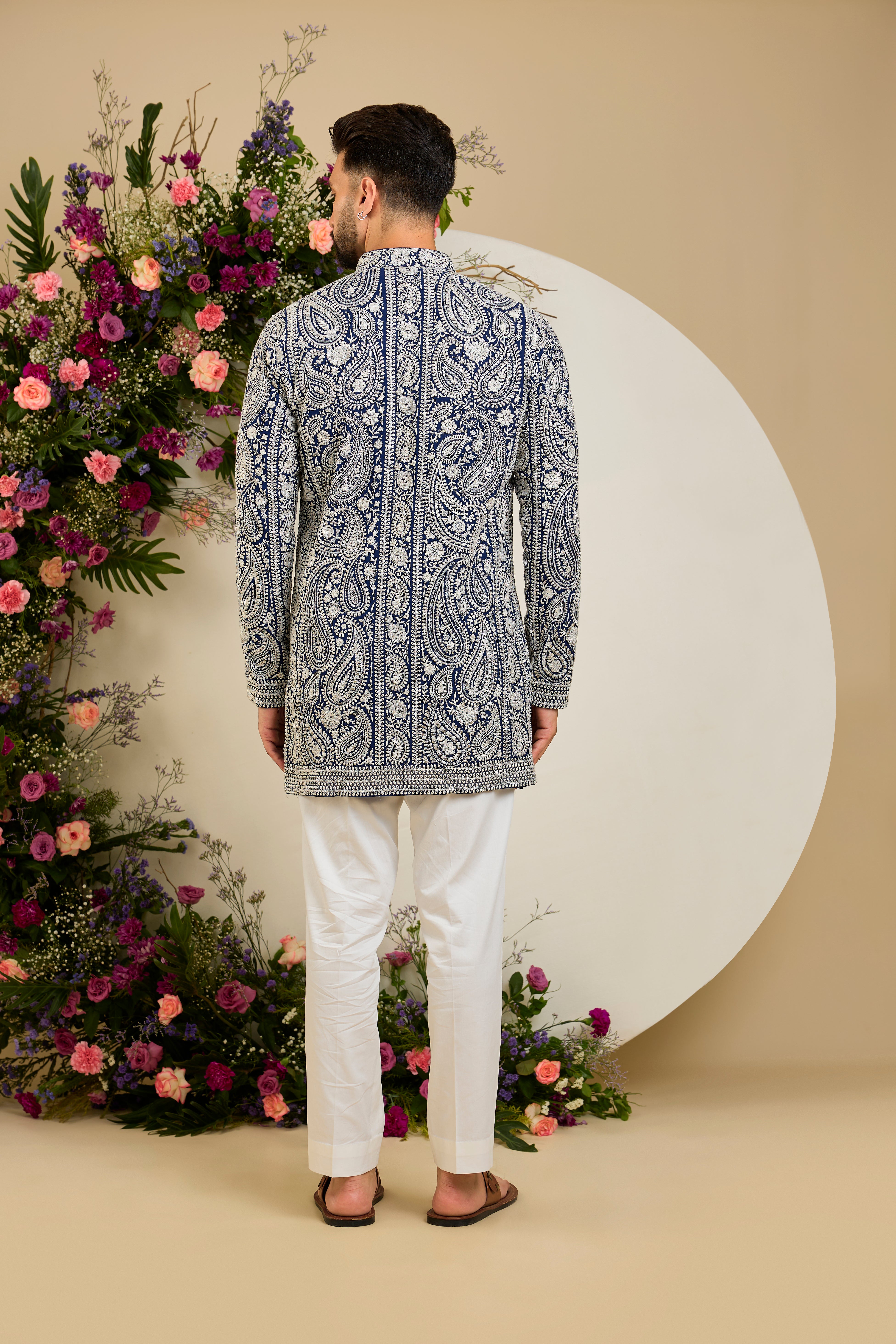Royal blue short Chikankari kurta with paisley embroidery, ivory and white threadwork, and delicate sequin detailing for timeless elegance.