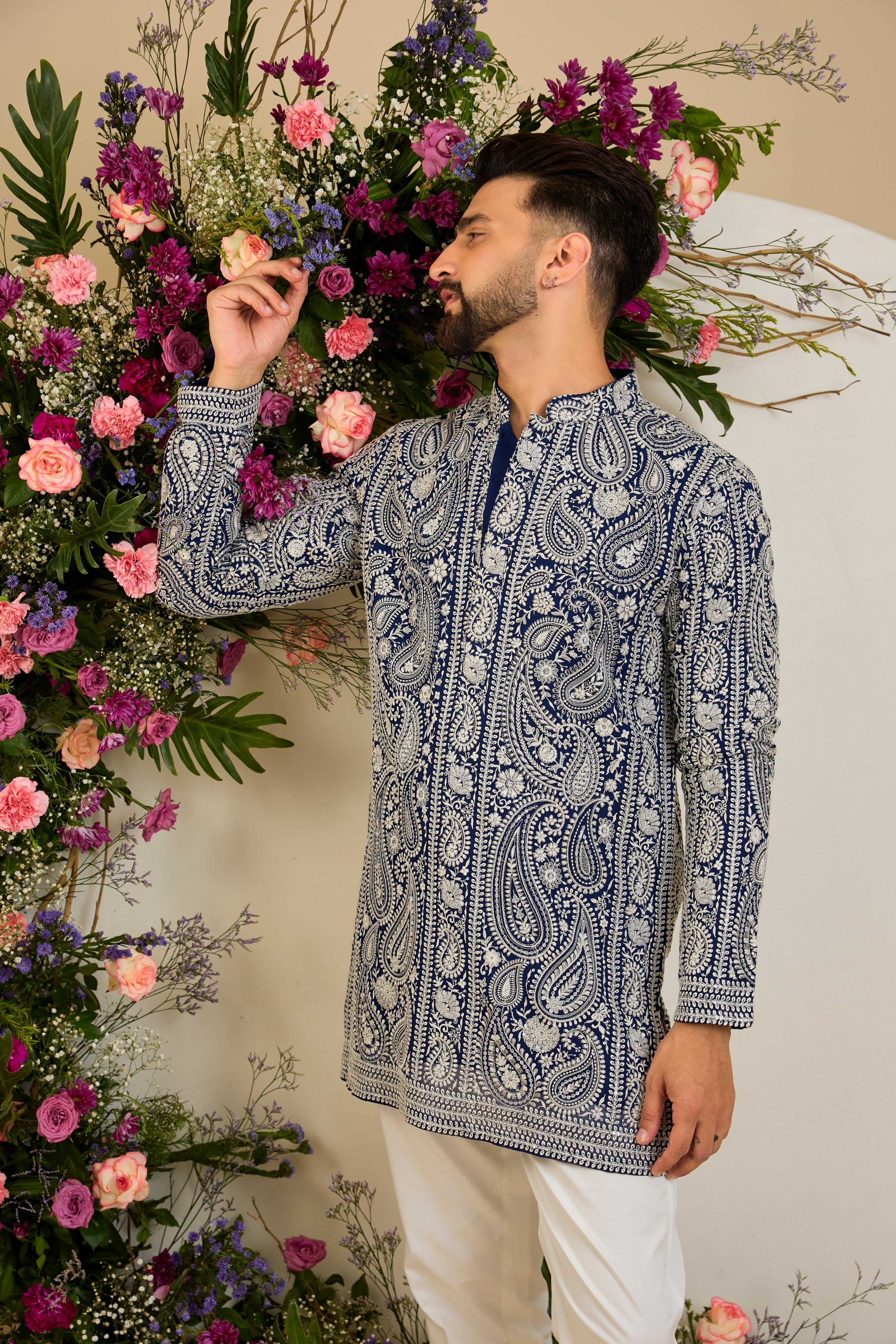 Royal blue short Chikankari kurta with paisley embroidery, ivory and white threadwork, and delicate sequin detailing for timeless elegance.