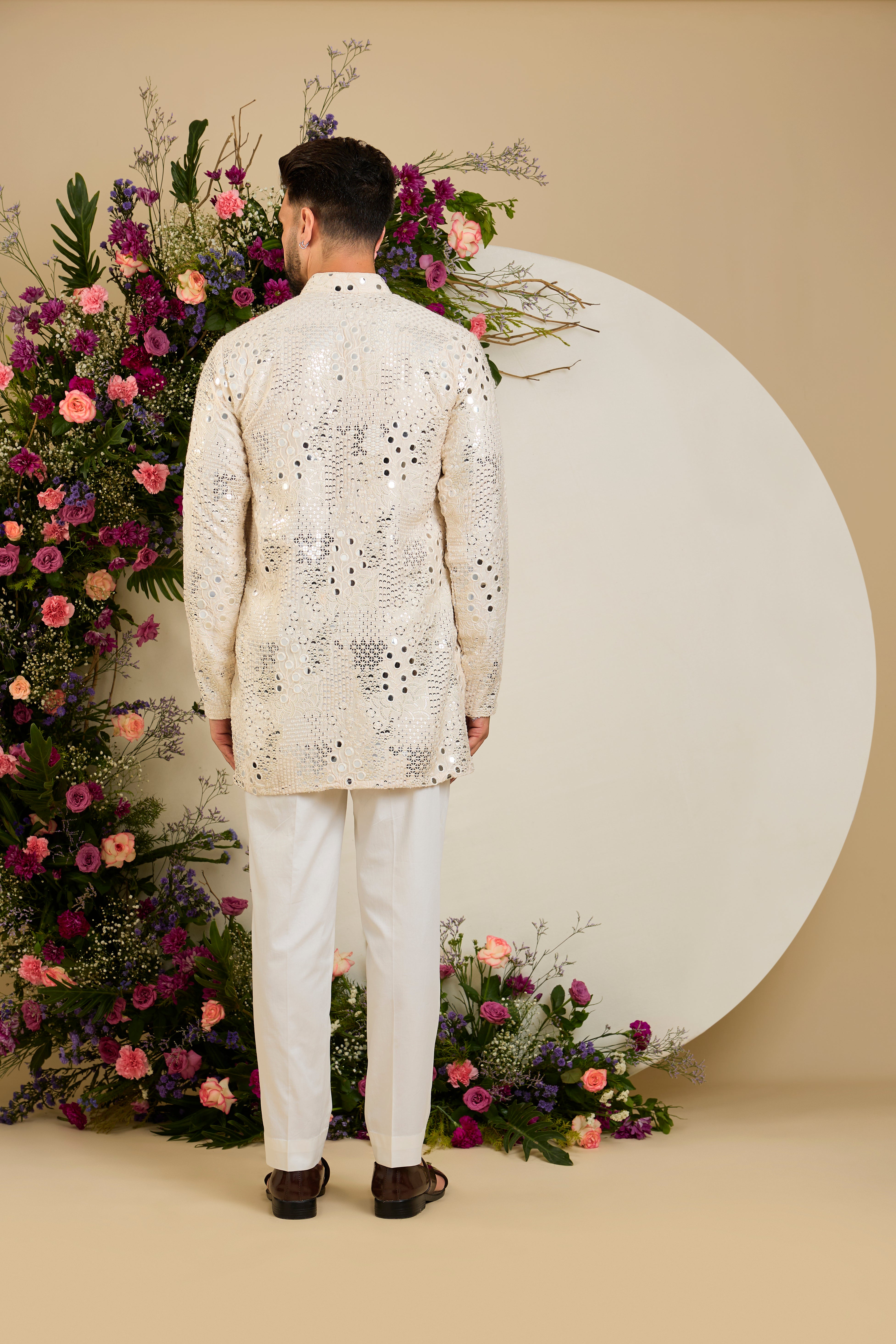 Cream short mirror work kurta with intricate embroidery, and delicate sequin detailing for timeless sophistication.
