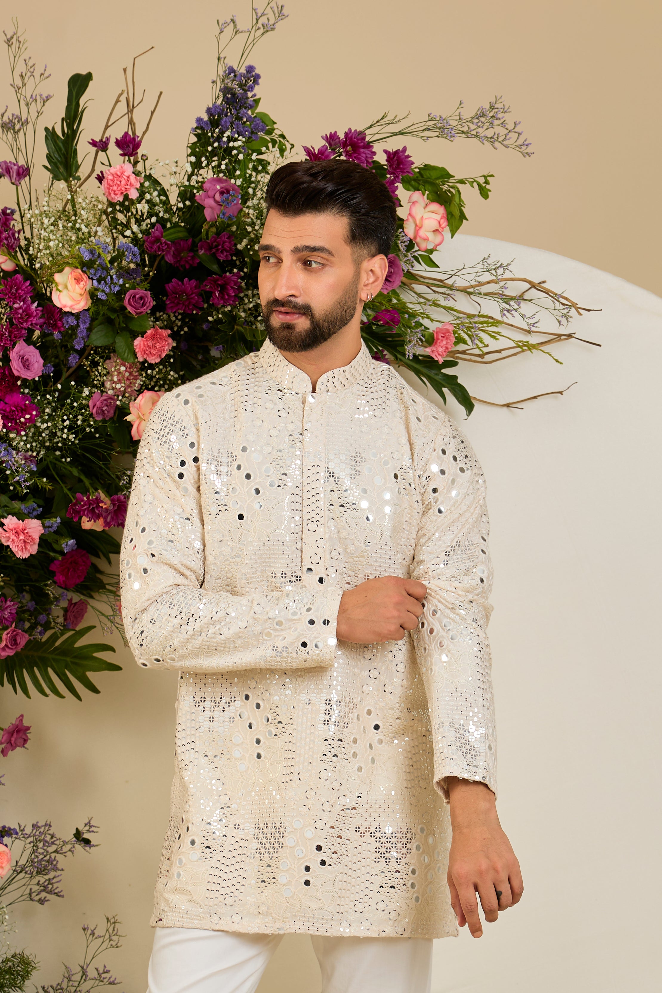 Cream short mirror work kurta with intricate embroidery, and delicate sequin detailing for timeless sophistication.