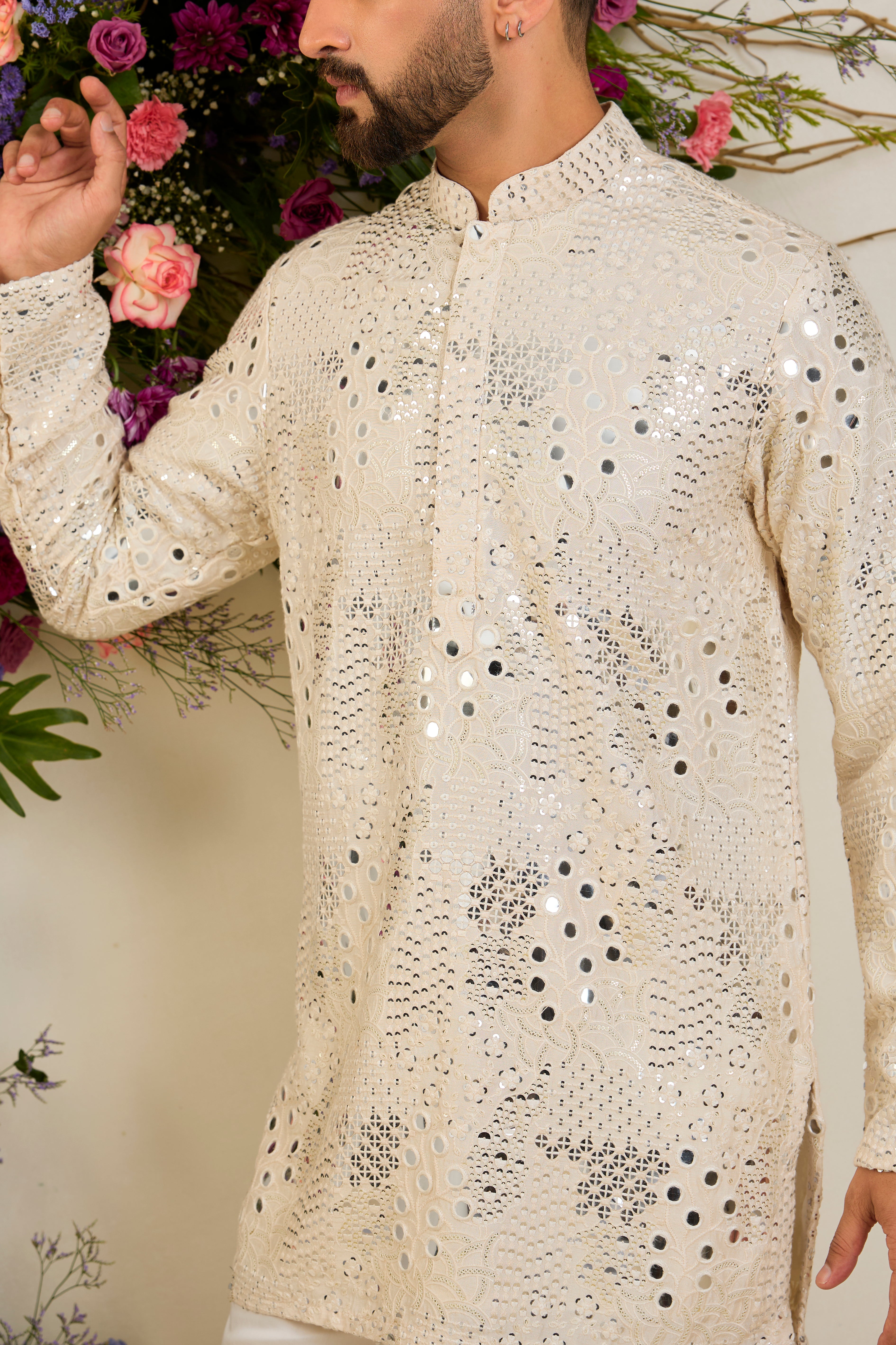 Cream short mirror work kurta with intricate embroidery, and delicate sequin detailing for timeless sophistication.