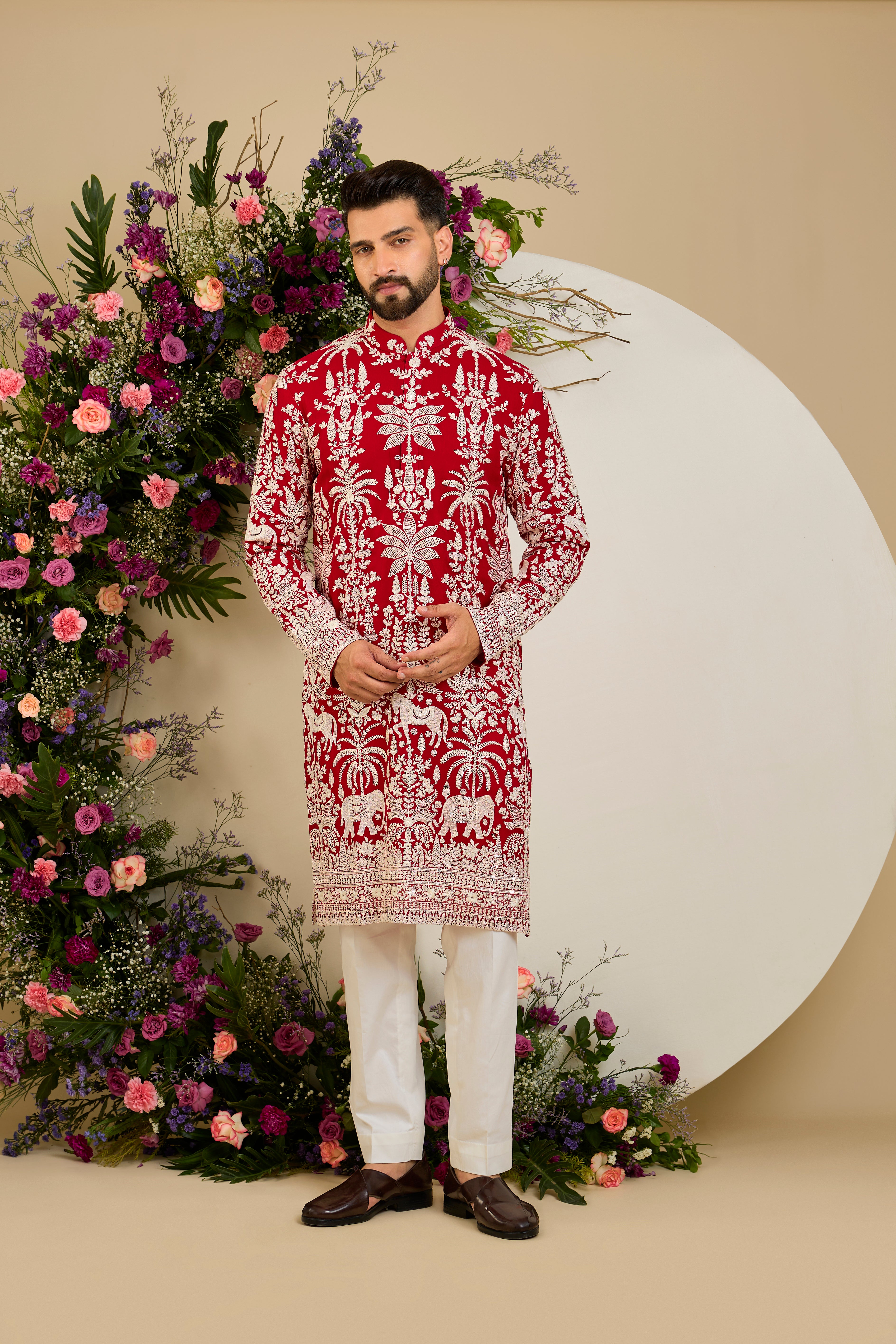 Red  kurta with tropical flora and fauna embroidery, ivory threadwork, and delicate sequin detailing for refined occasion wear.