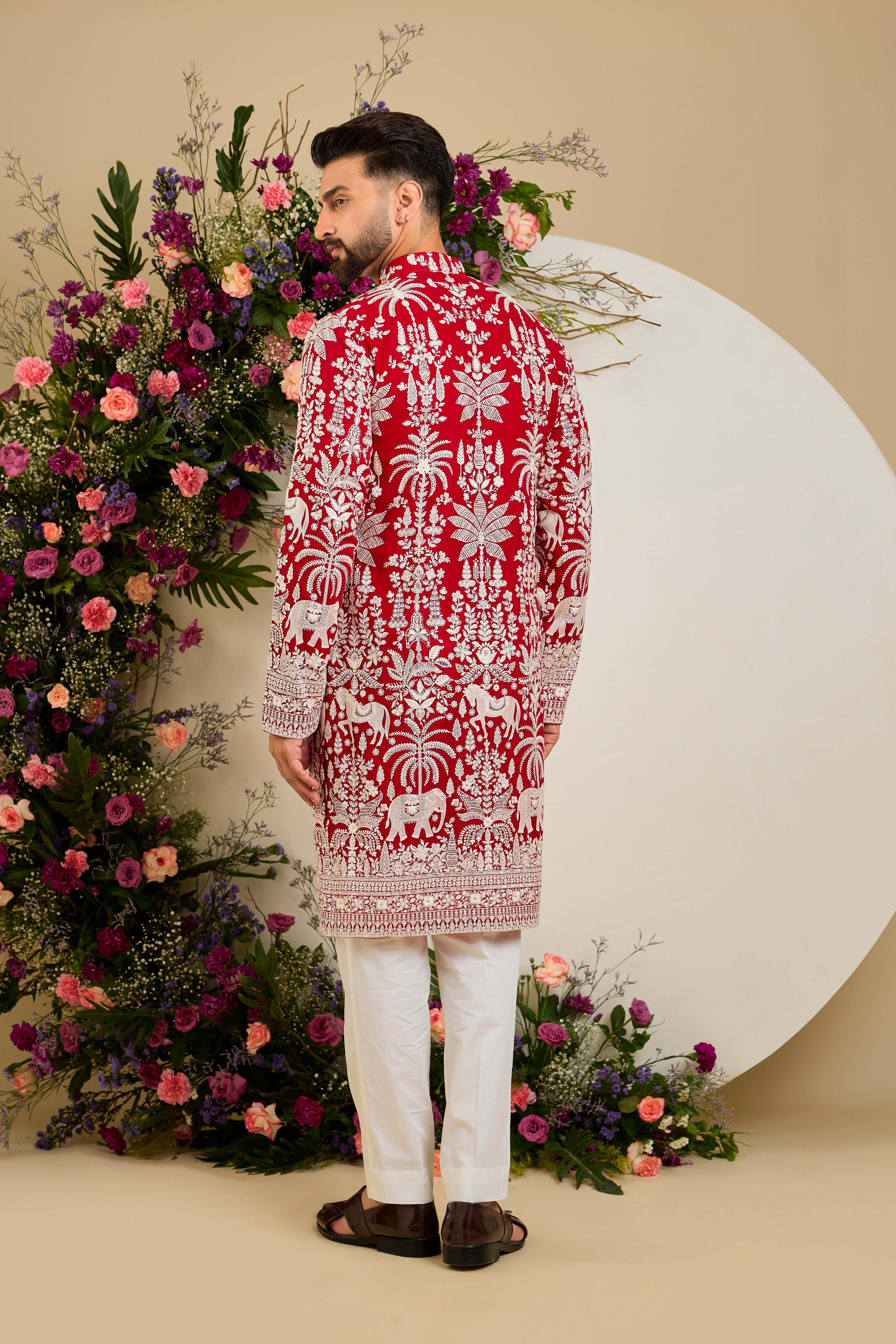 Red  kurta with tropical flora and fauna embroidery, ivory threadwork, and delicate sequin detailing for refined occasion wear.