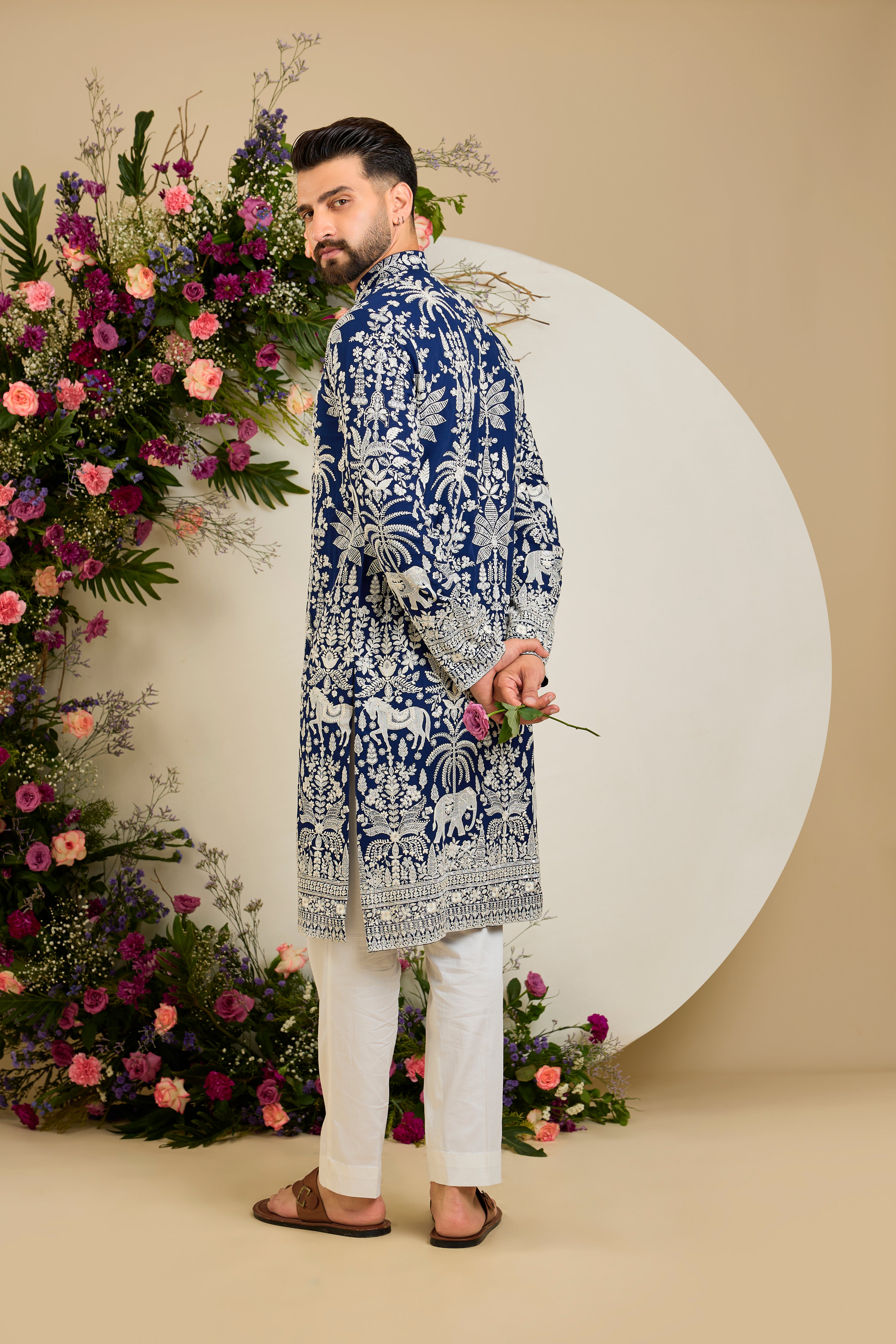 Royal blue kurta with tropical flora and fauna embroidery, ivory threadwork, and delicate sequin detailing for refined occasion wear.