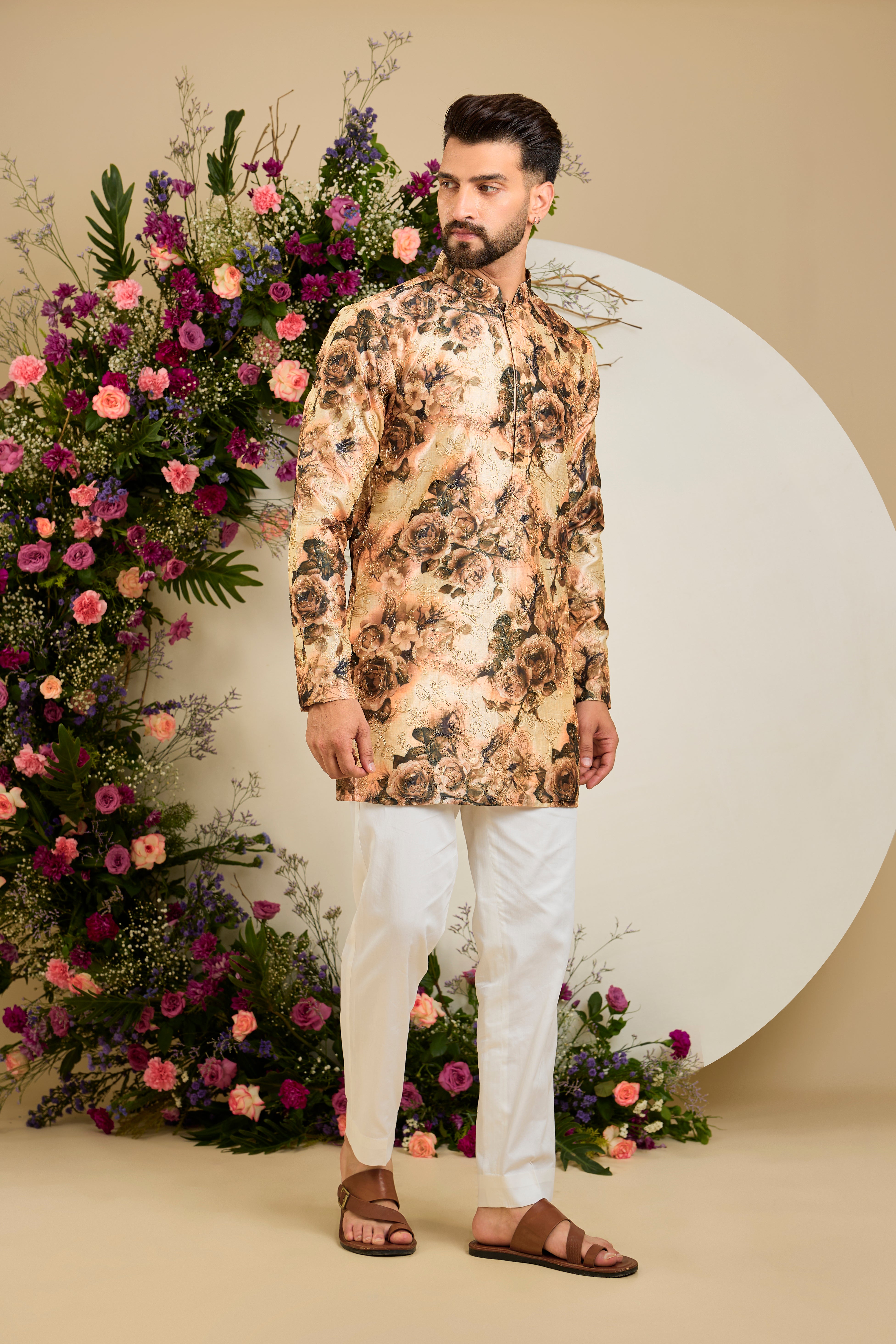 Showcasing a vibrant multi-coloured floral backdrop, this short kurta is elevated with  refined aari craftsmanship .An exceptional expression of contemporary couture and timeless elegance.