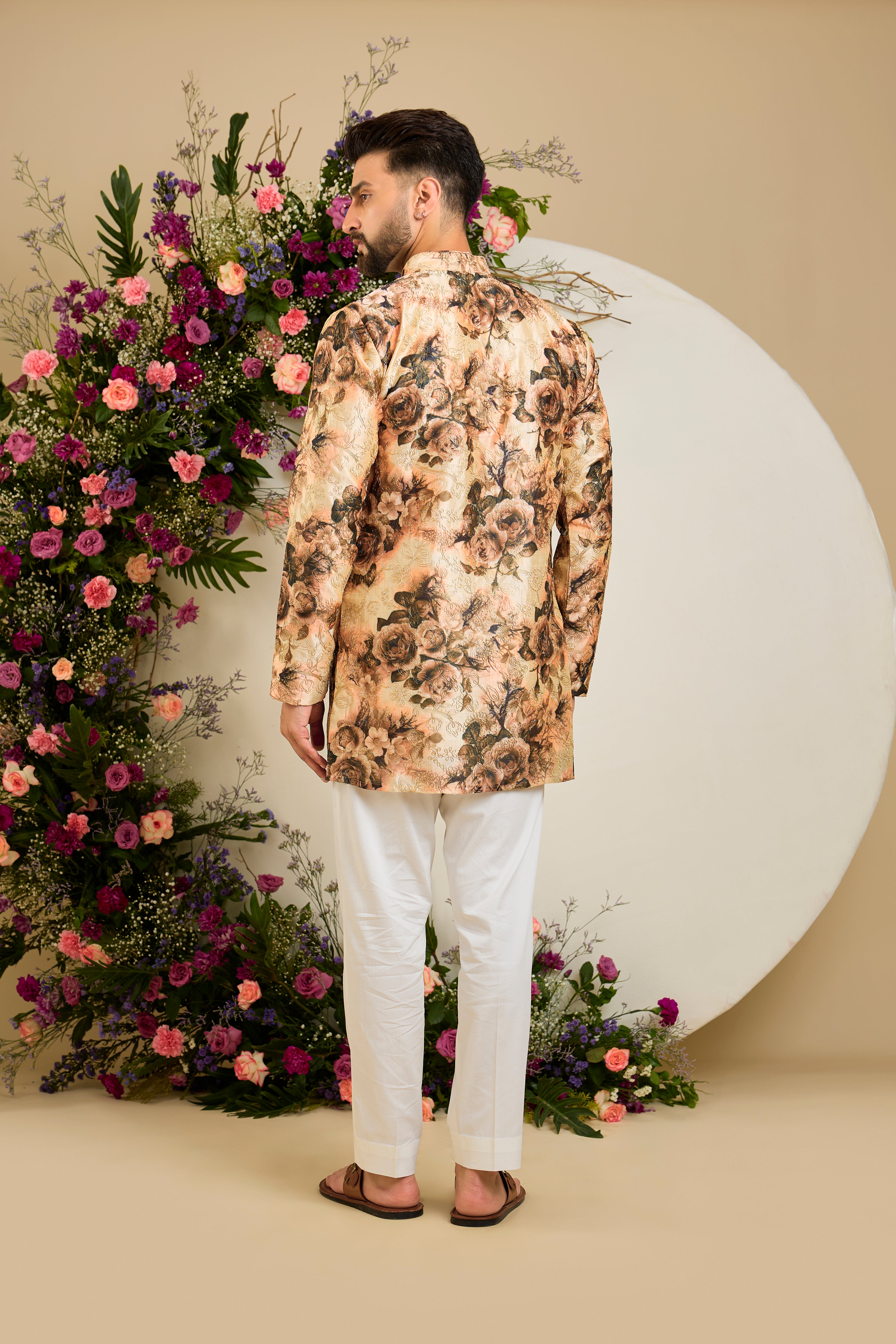 Showcasing a vibrant multi-coloured floral backdrop, this short kurta is elevated with  refined aari craftsmanship .An exceptional expression of contemporary couture and timeless elegance.