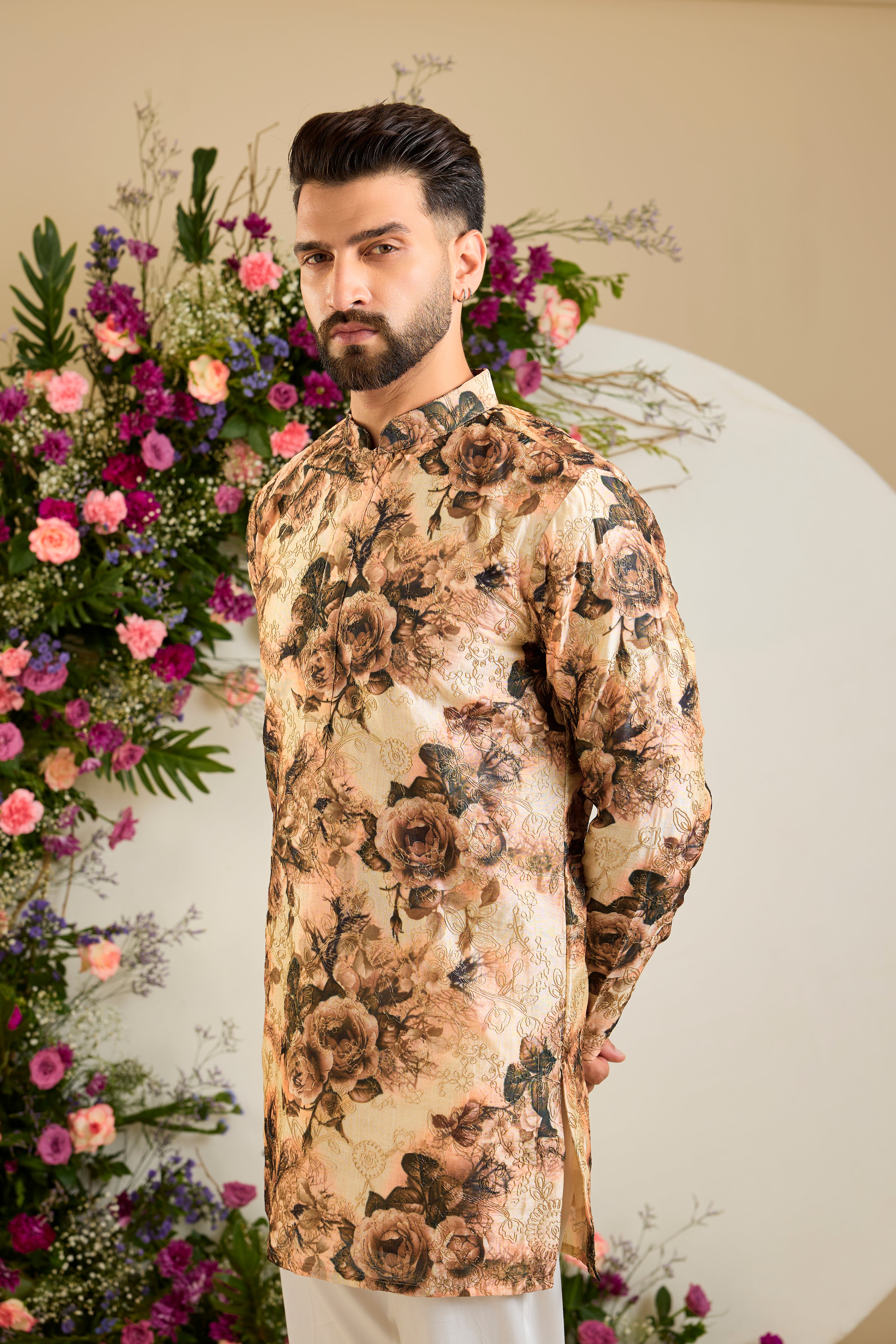 Showcasing a vibrant multi-coloured floral backdrop, this short kurta is elevated with  refined aari craftsmanship .An exceptional expression of contemporary couture and timeless elegance.