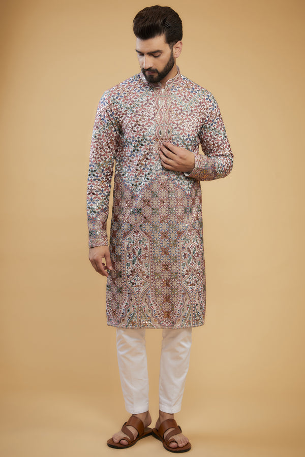 White Chikankari kurta with intricate multi-thread work, detailed neckline and gold leather patch-work.