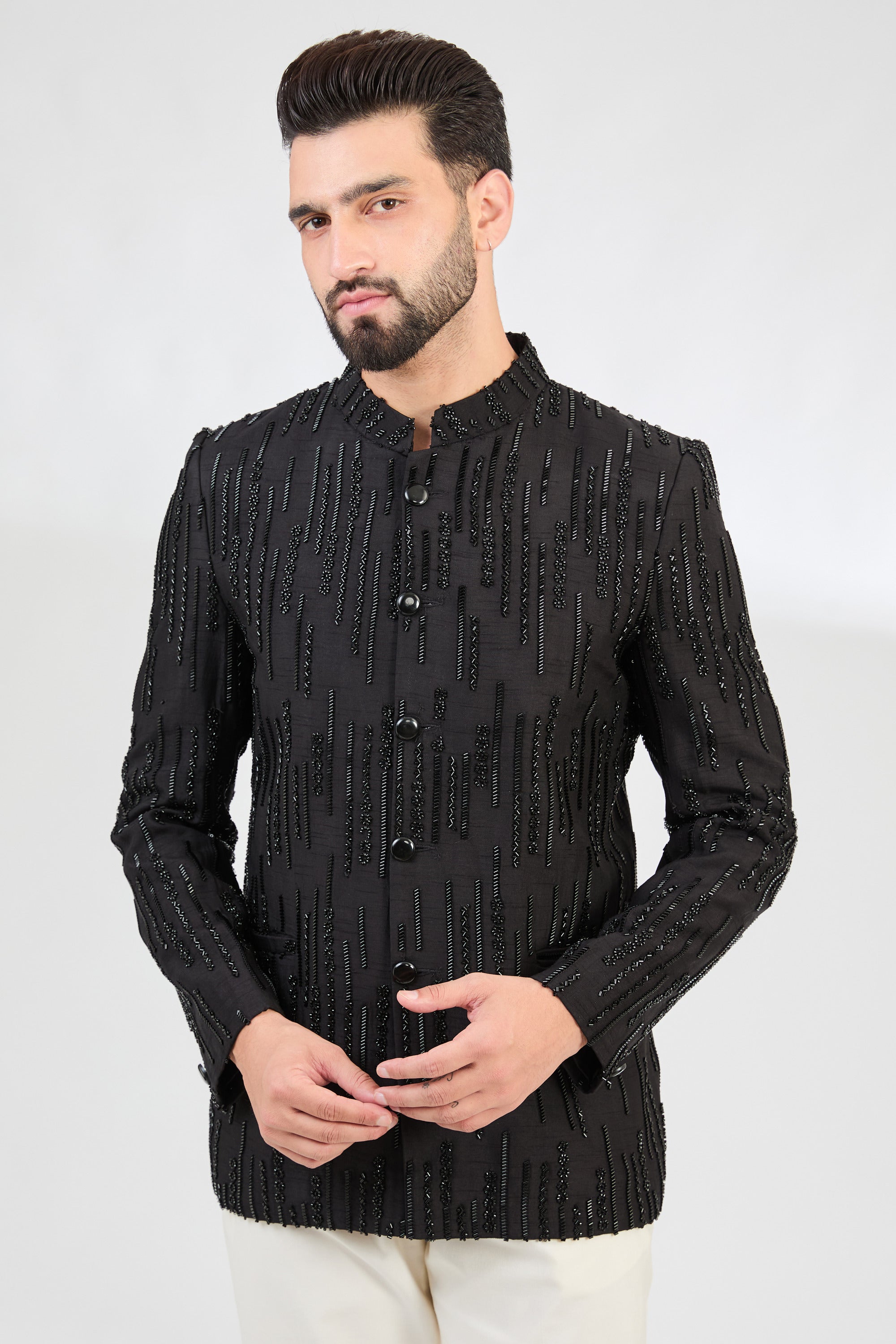 Signature black bandhgala delicately embellished with heavy cut-dana embroidery. - kasbahmen