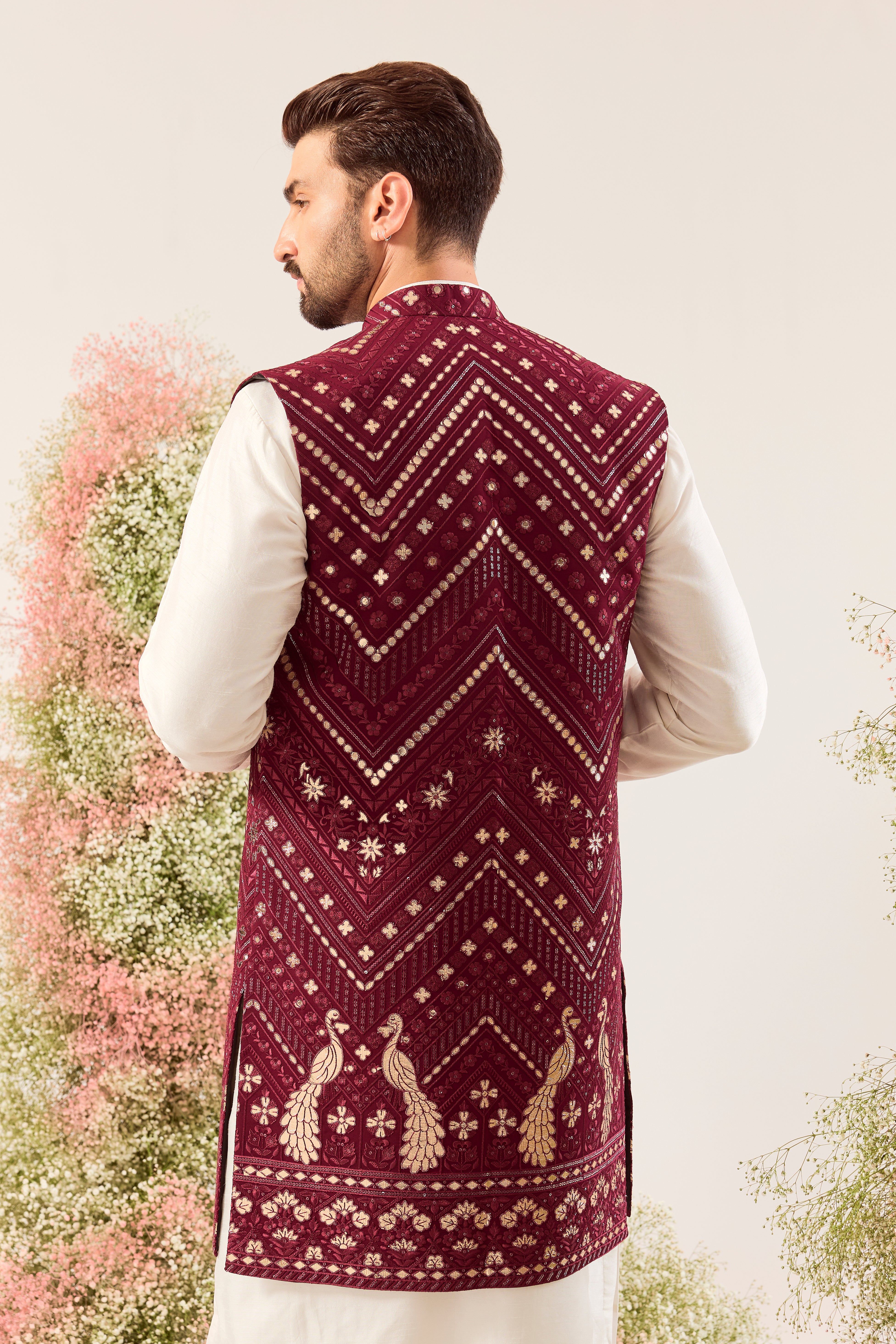 magenta long open jacket with detailed leather patchwork and peacock motifs