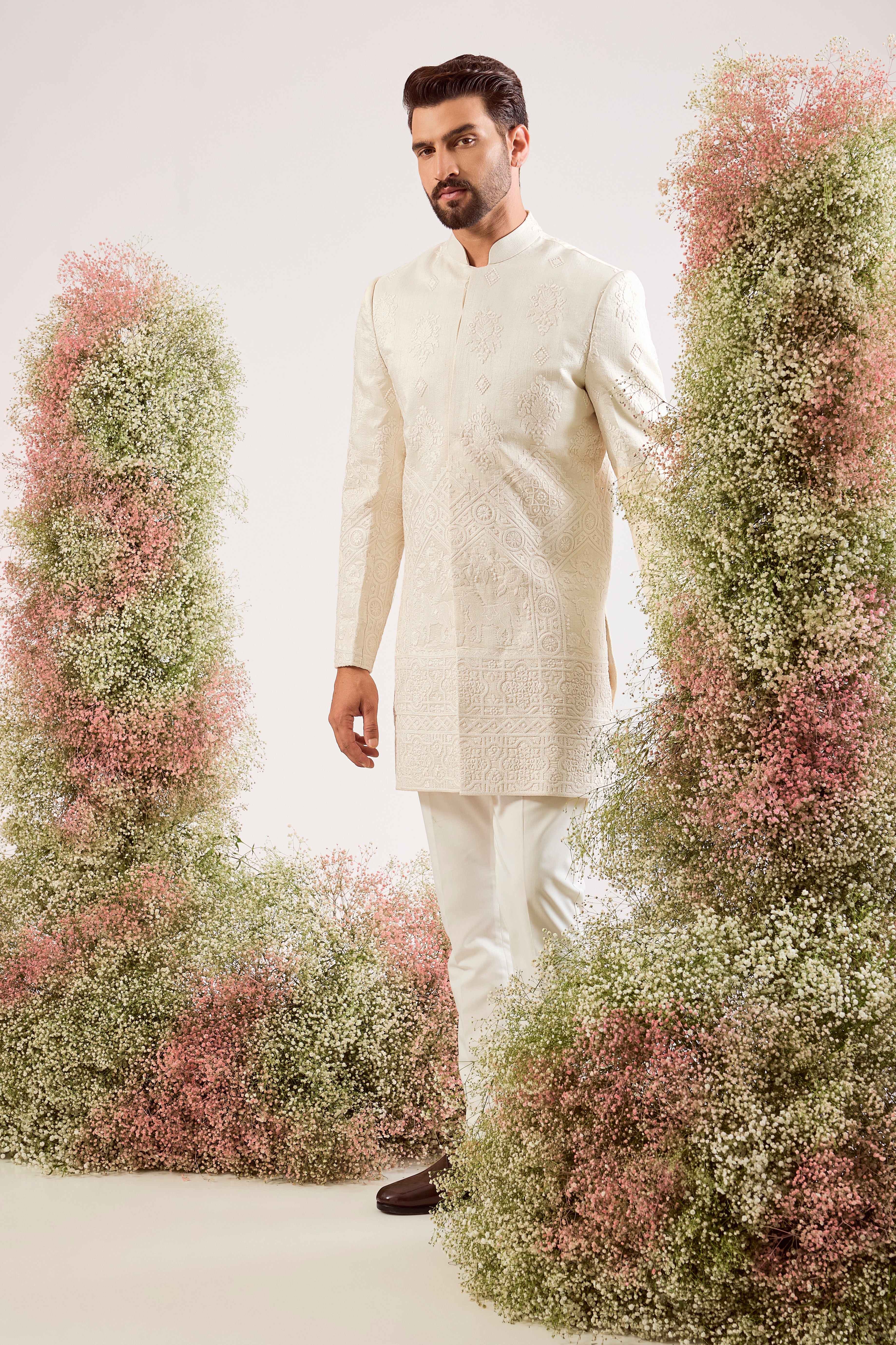 creame threadwork sherwani with intricate horse figures