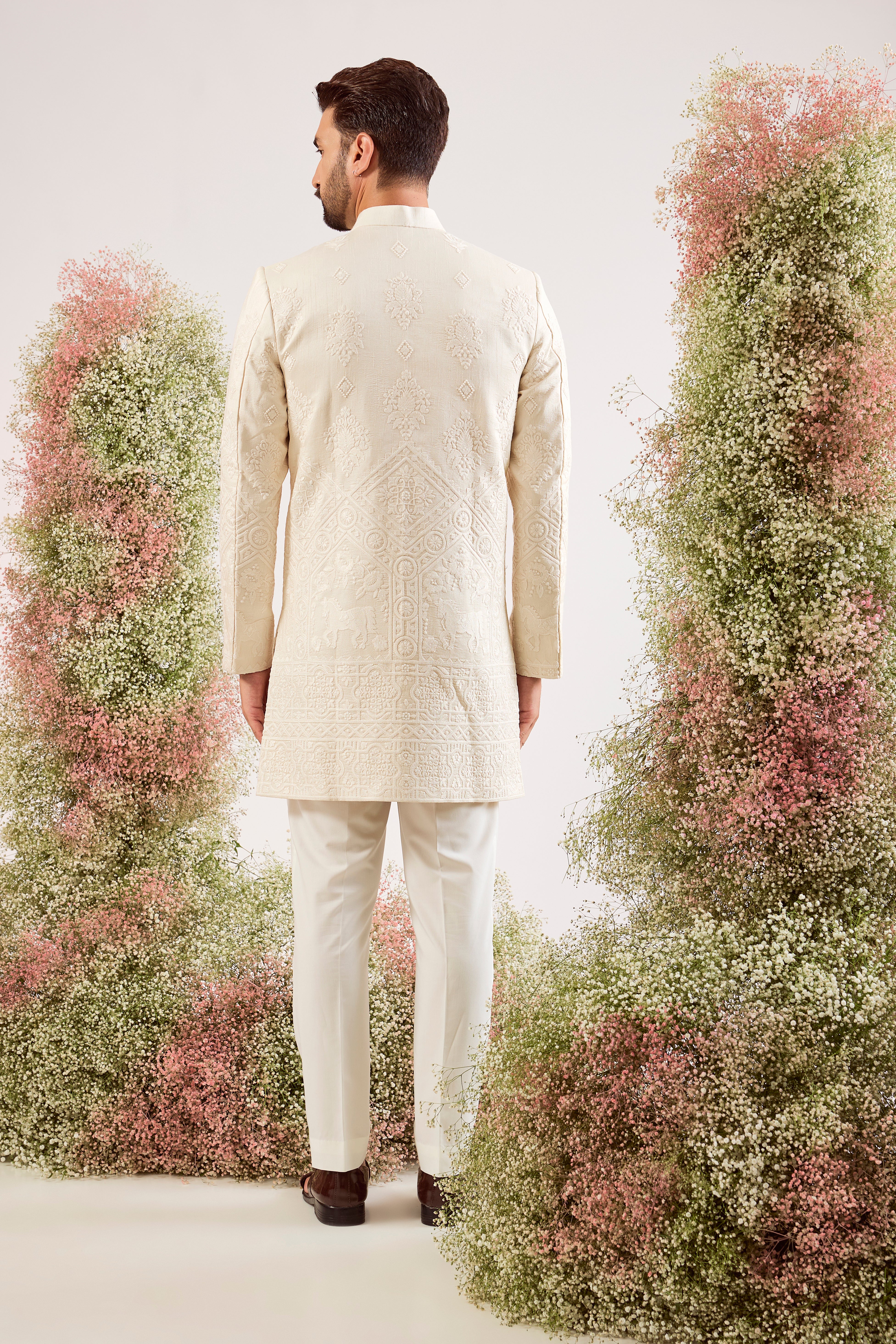 creame threadwork sherwani with intricate horse figures