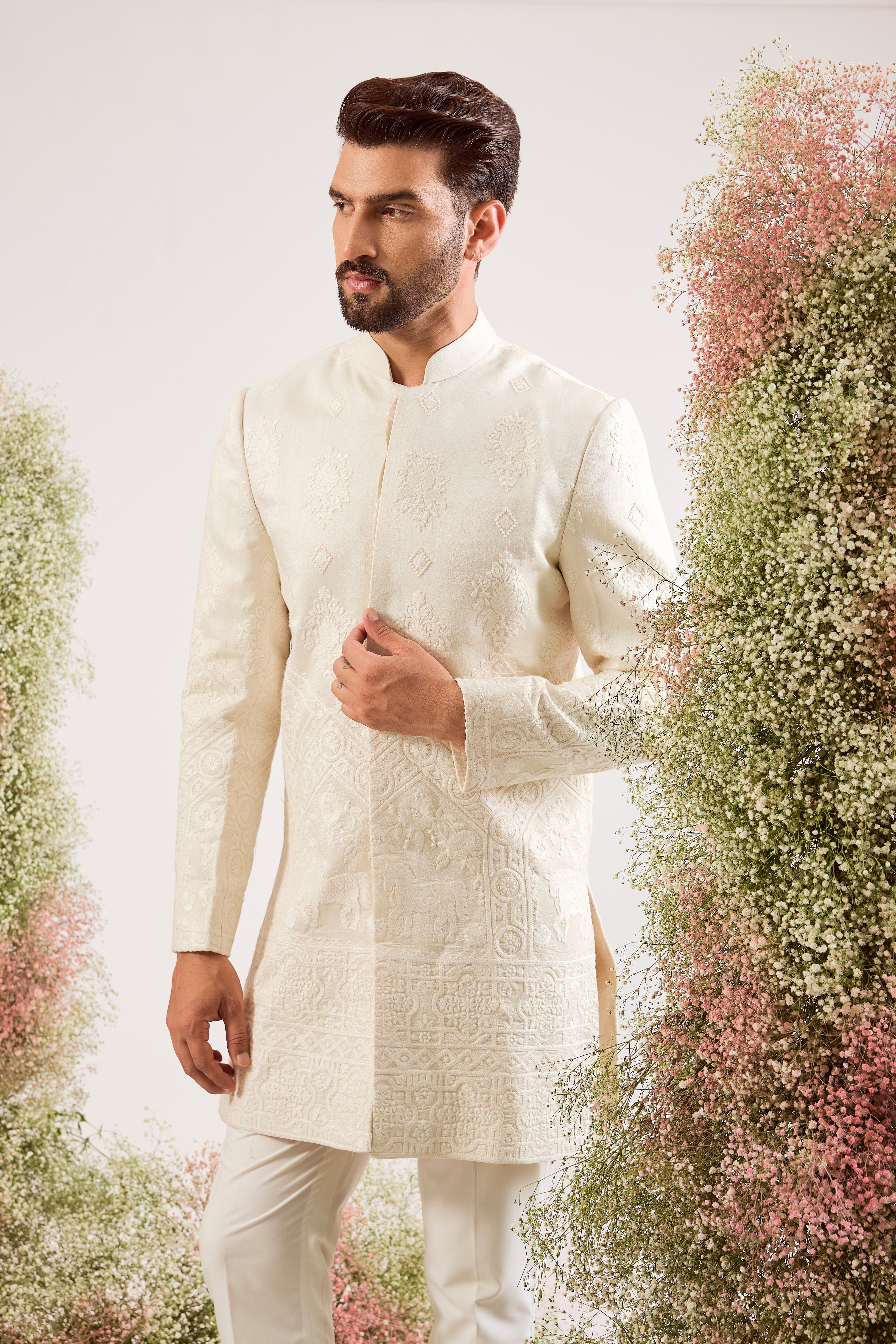 creame threadwork sherwani with intricate horse figures