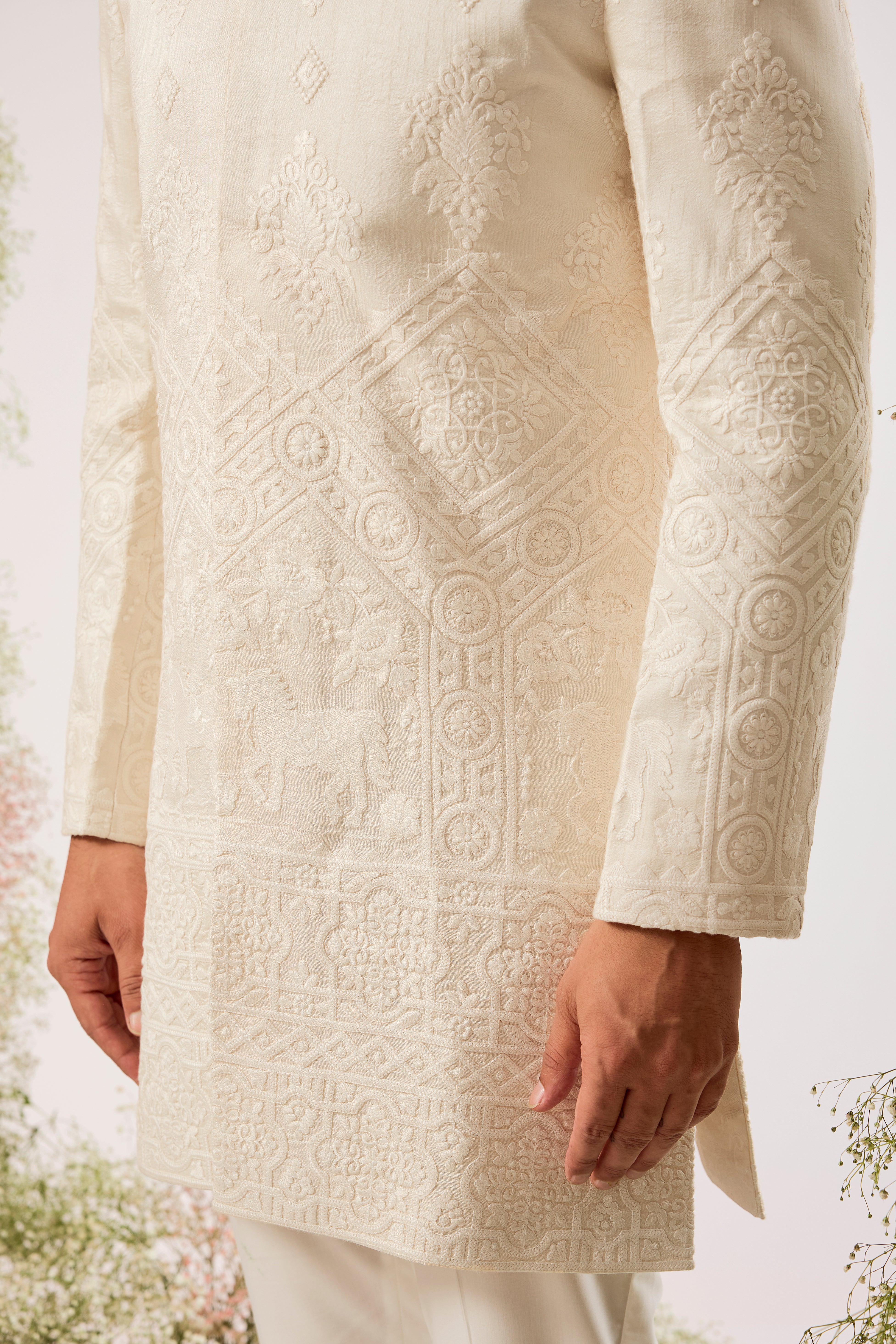 creame threadwork sherwani with intricate horse figures