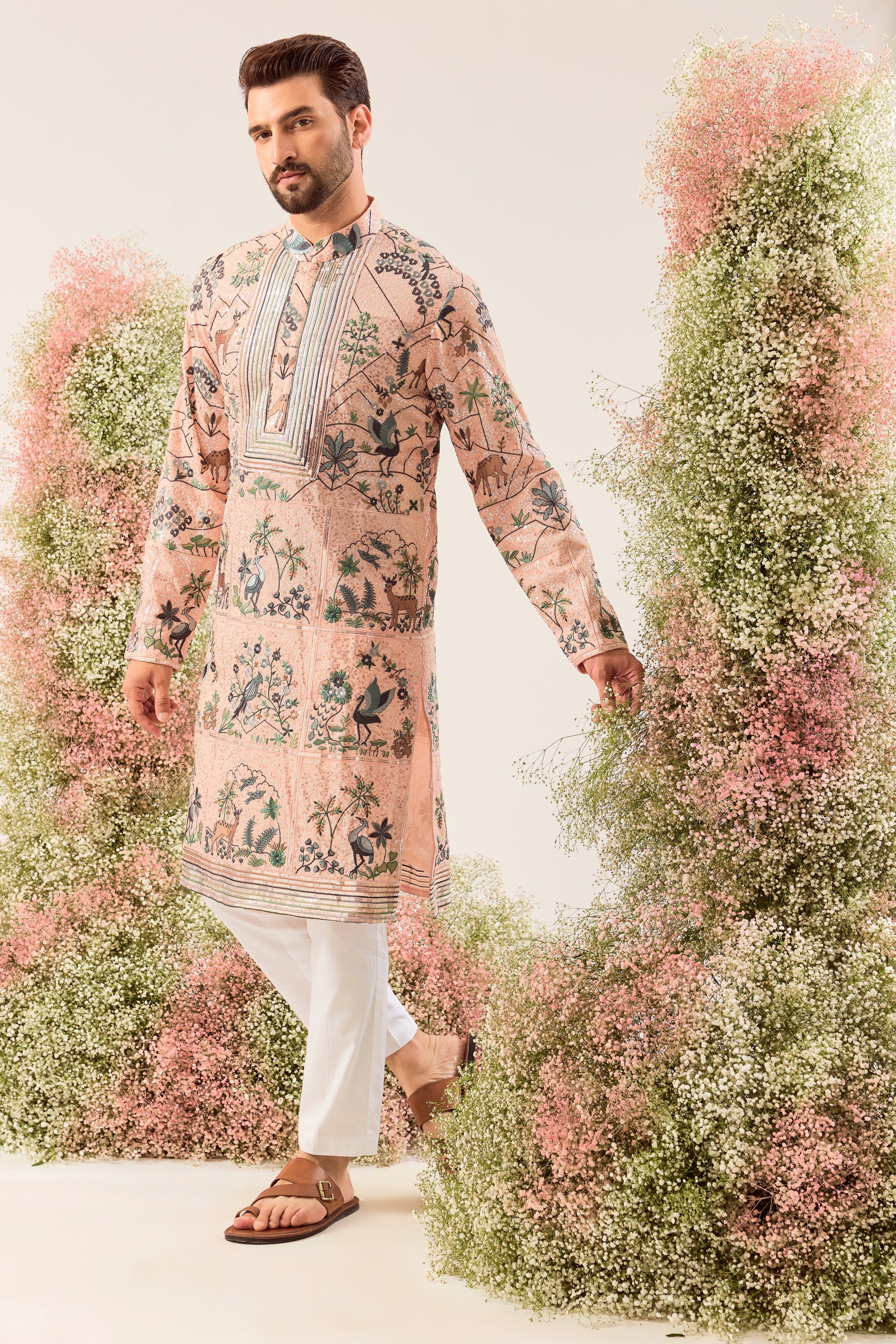 peach sequined kurta with detailed flora and fauna figures and intricate neckline