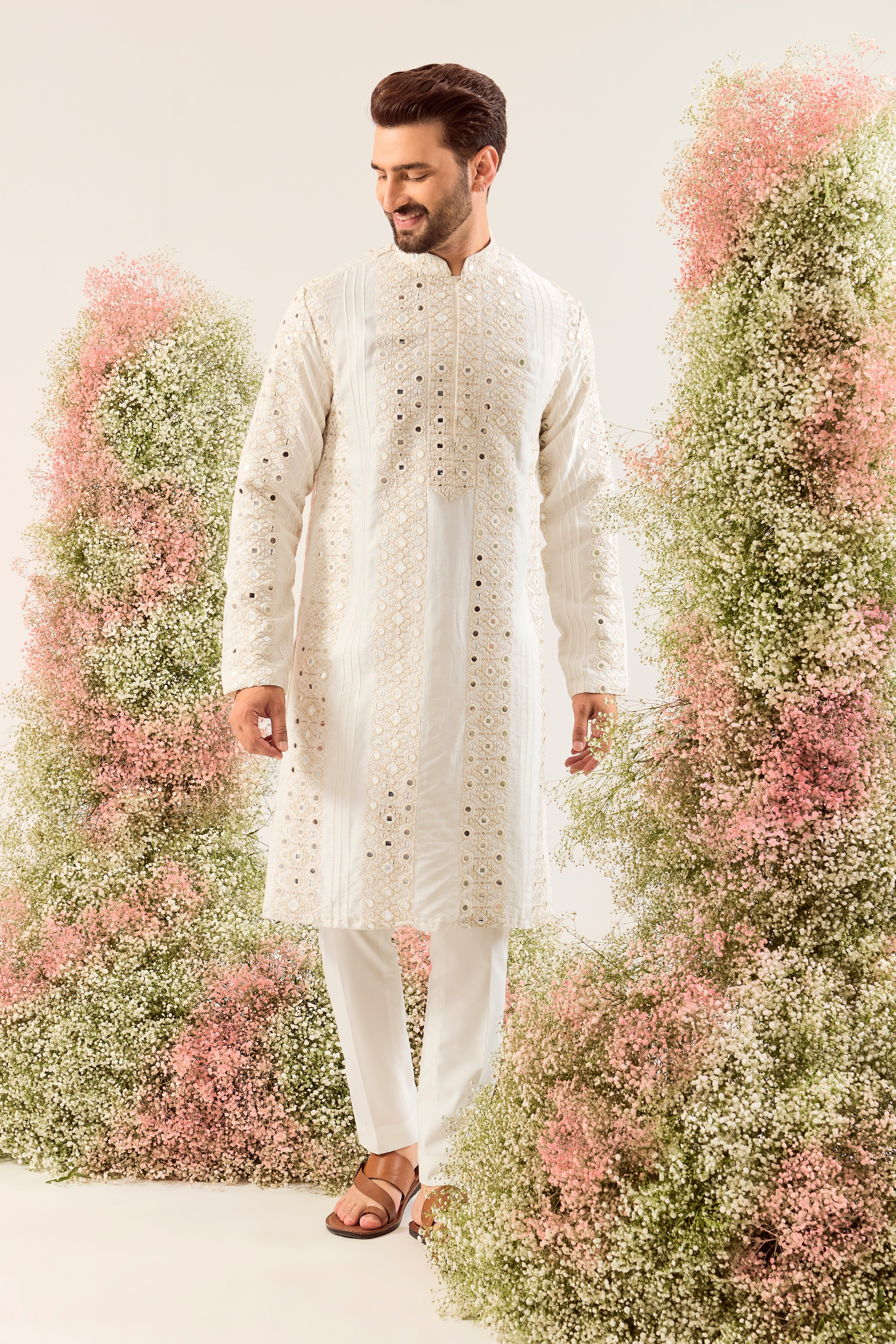 white mirror work kurta with deatiled pintucks and neckline