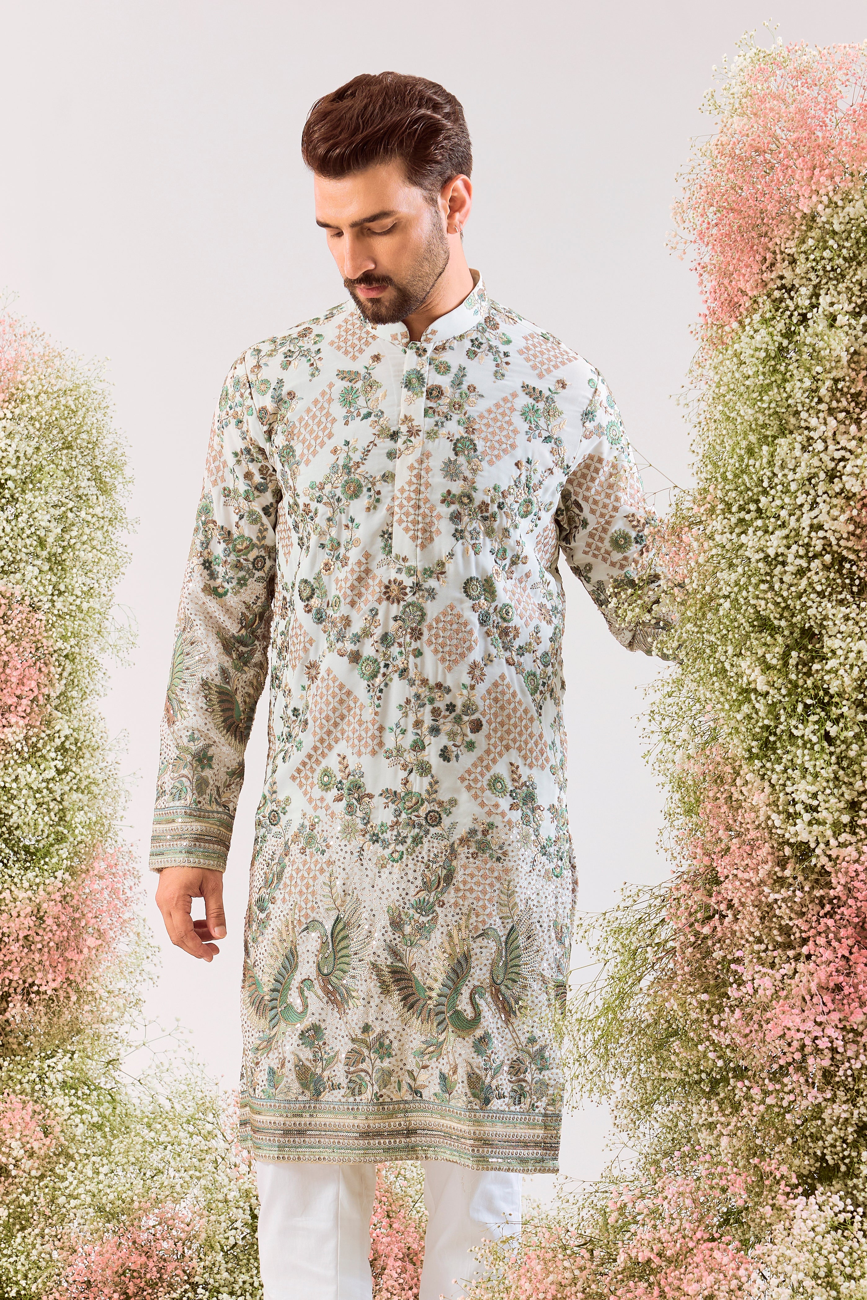 white sequined kurta with intricate flora and fauna embroidery