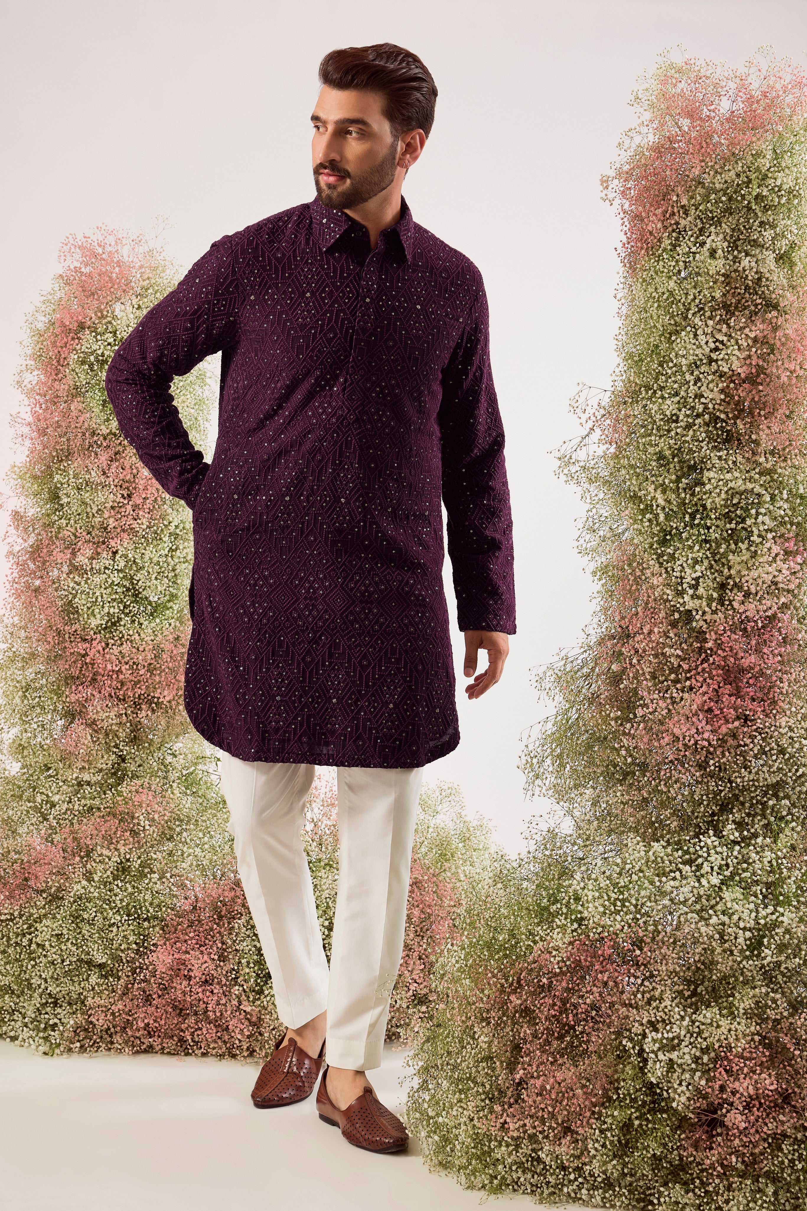 This elegant wine geometrically embroidered short pathani kurta is a masterpiece of modern design.