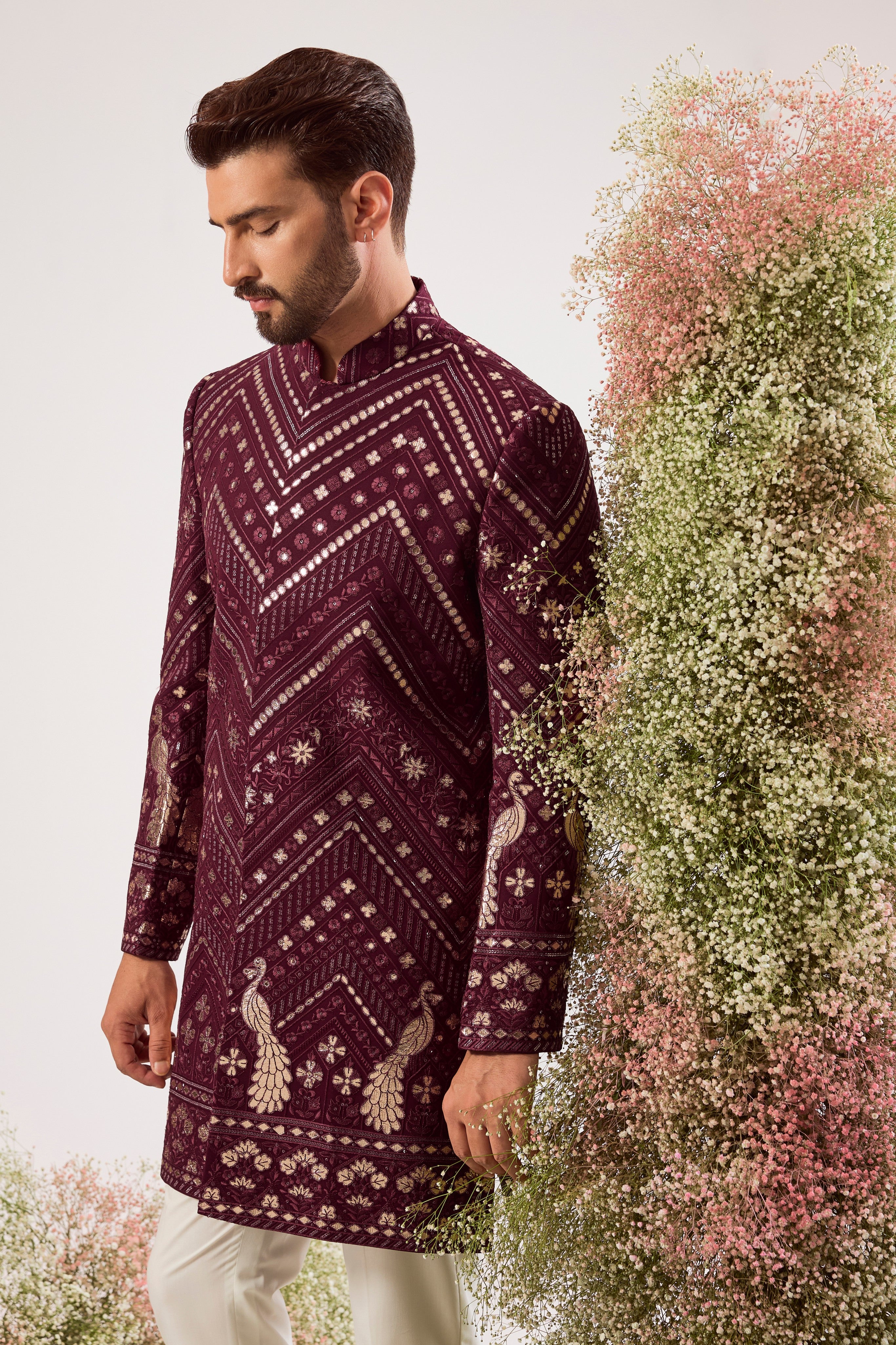 This majestic magenta short Indo-western is a true work of art, designed for the man who dares to be different.