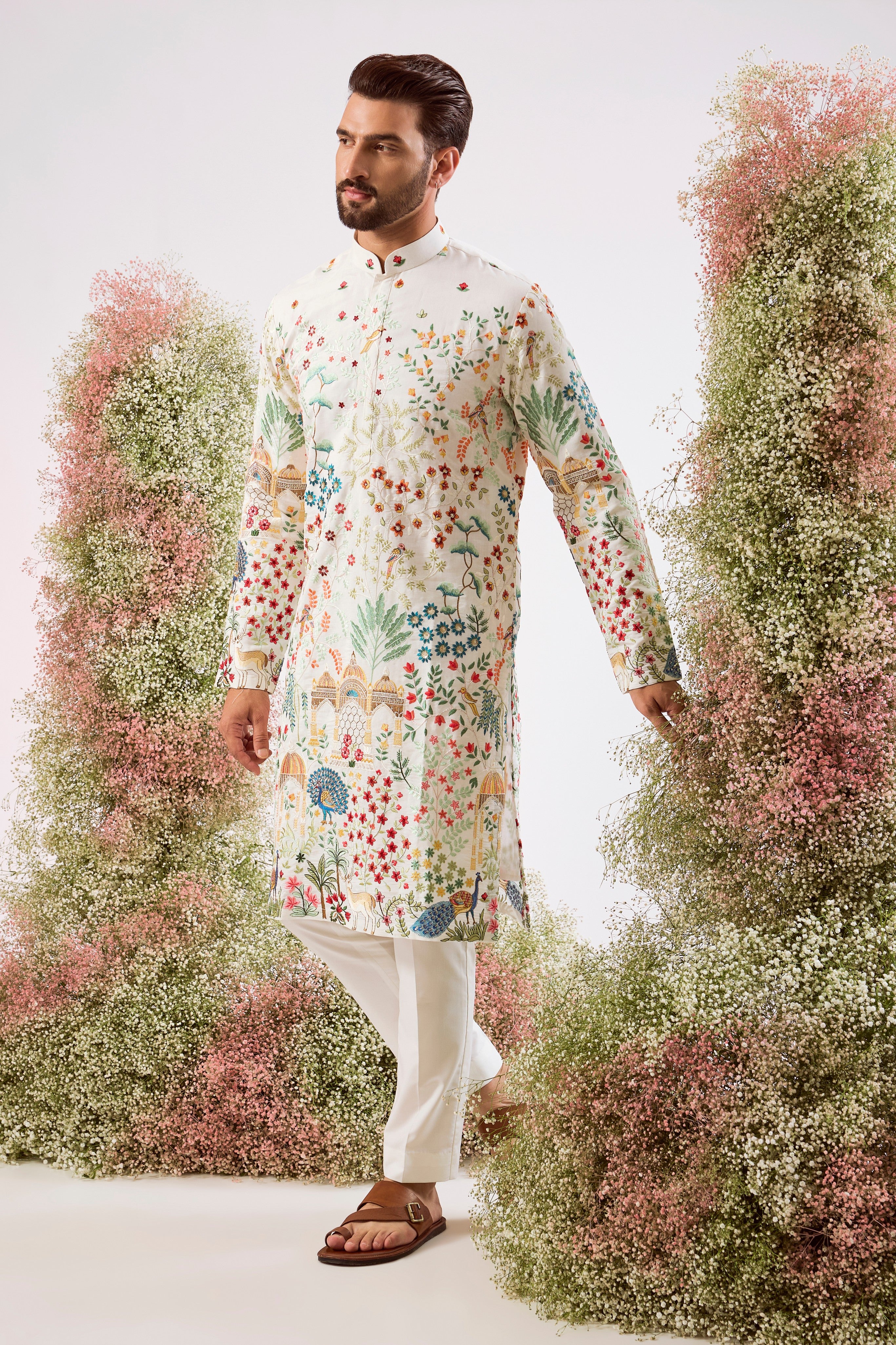white royal heritage chikankari kurta with intricate interplay of flora and fauna and detailed mughar darbar figures