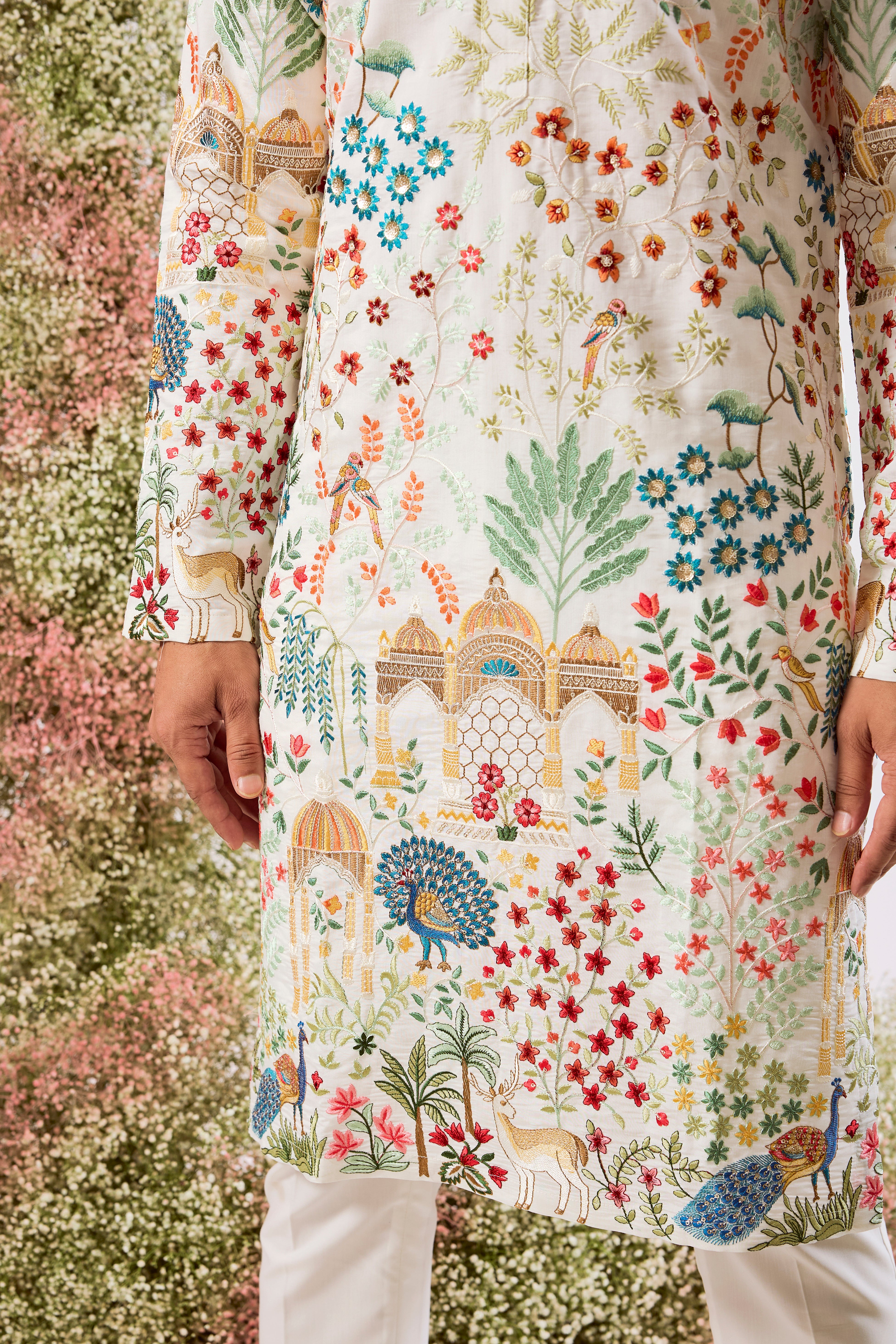 white royal heritage chikankari kurta with intricate interplay of flora and fauna and detailed mughar darbar figures