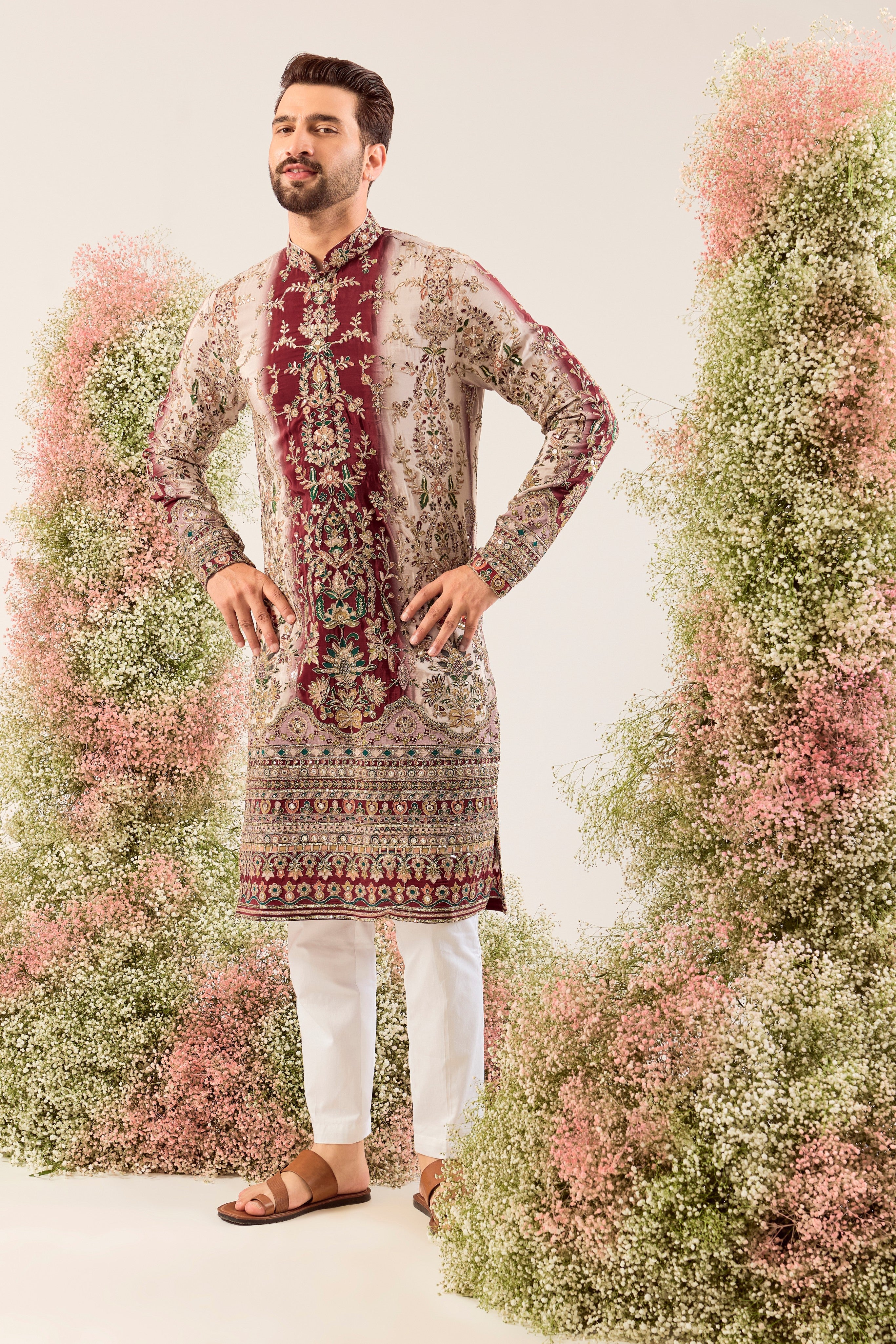 This striking maroon and ivory floral embroidered kurta is a masterpiece of refined artistry.
