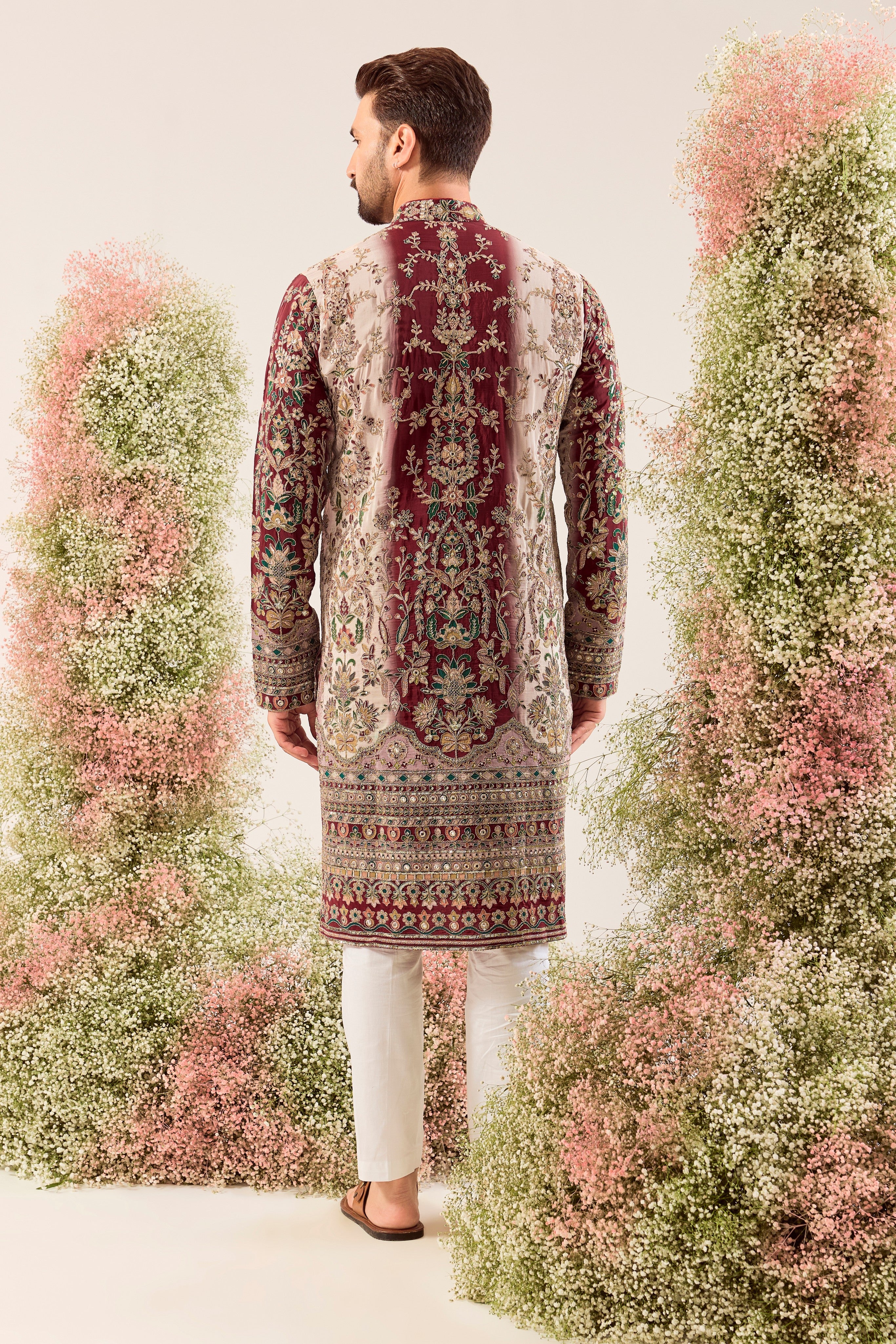 This striking maroon and ivory floral embroidered kurta is a masterpiece of refined artistry.