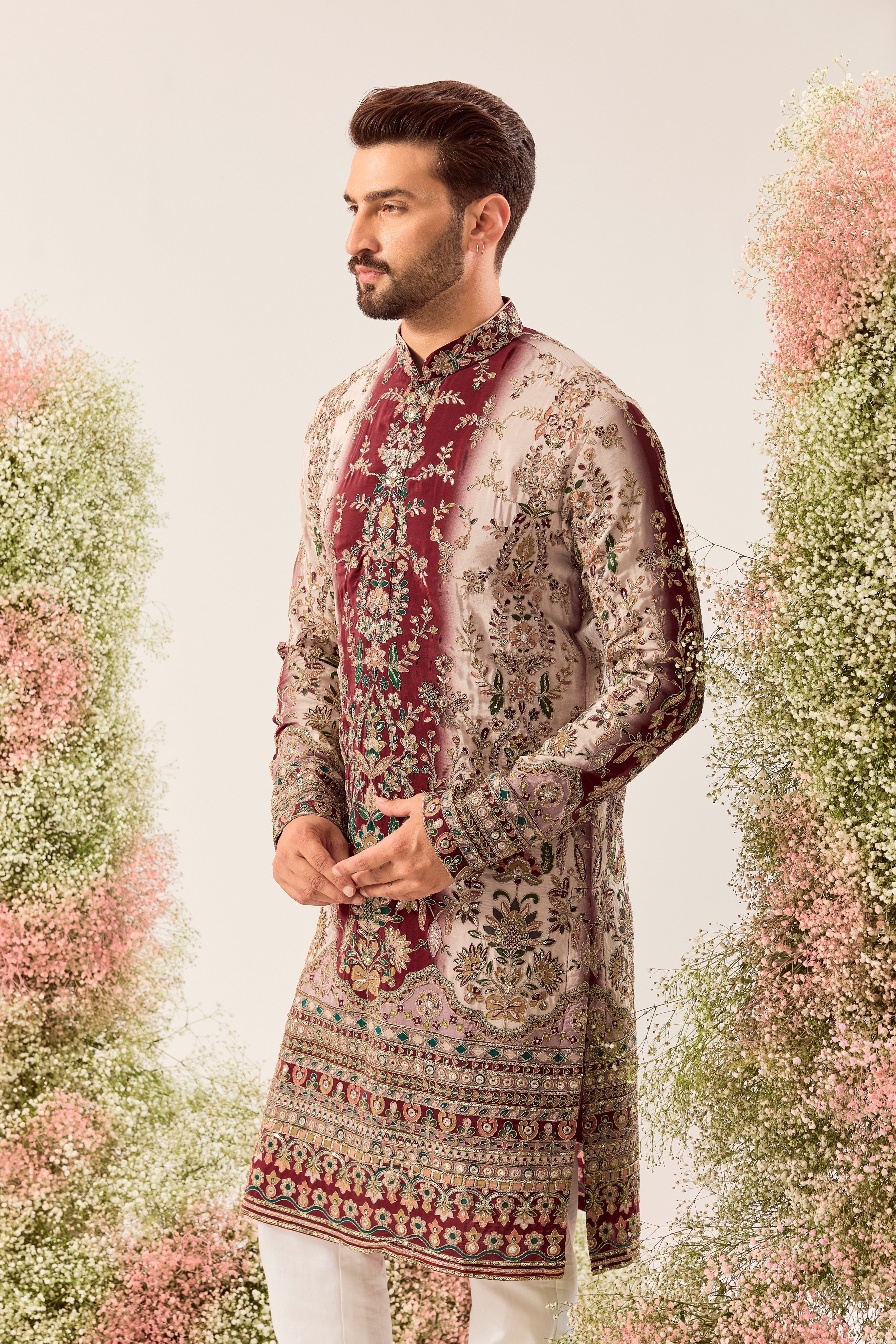This striking maroon and ivory floral embroidered kurta is a masterpiece of refined artistry.