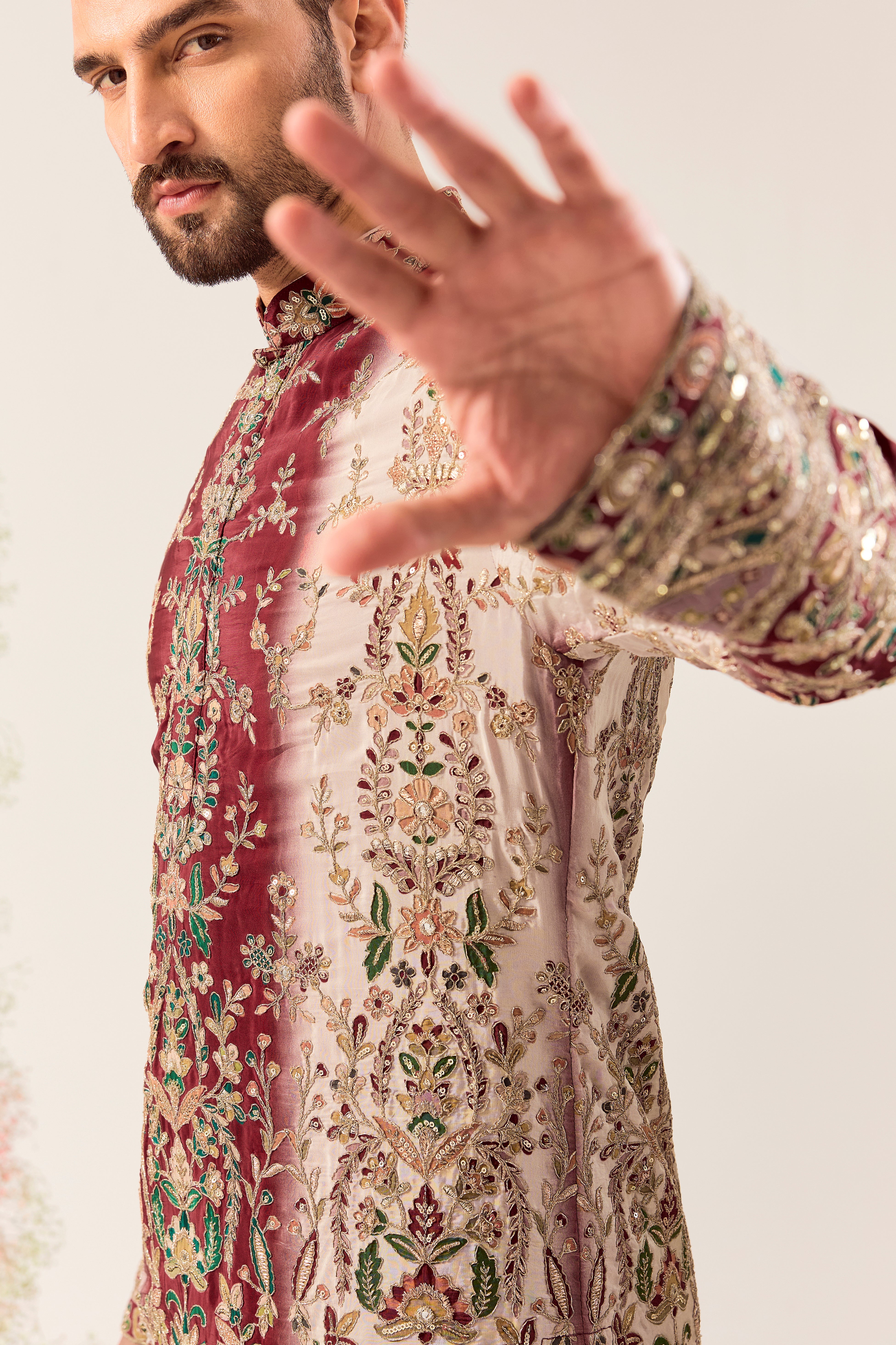 This striking maroon and ivory floral embroidered kurta is a masterpiece of refined artistry.