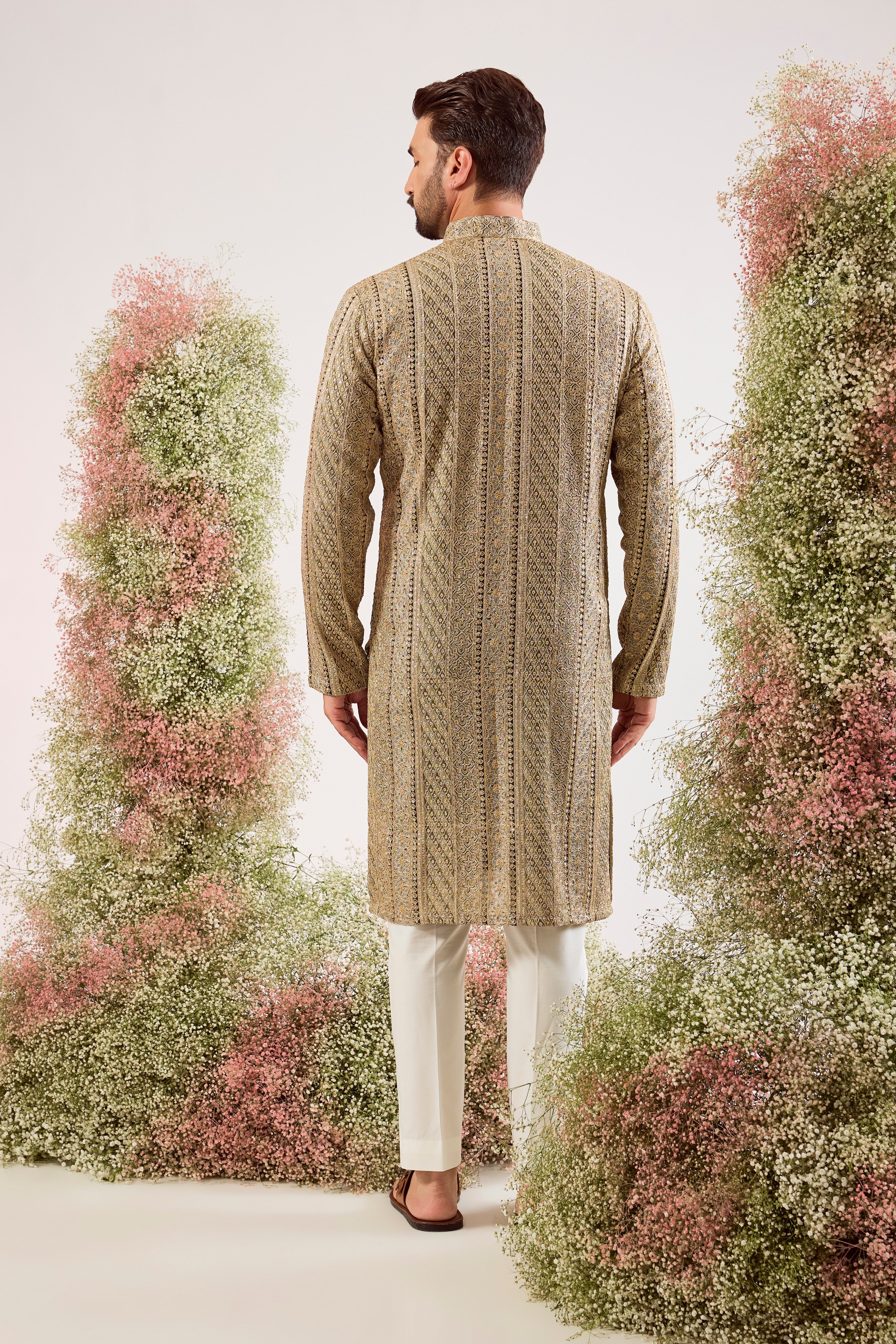 This striking mint green heavy zari work kurta is a masterpiece of modern luxury.