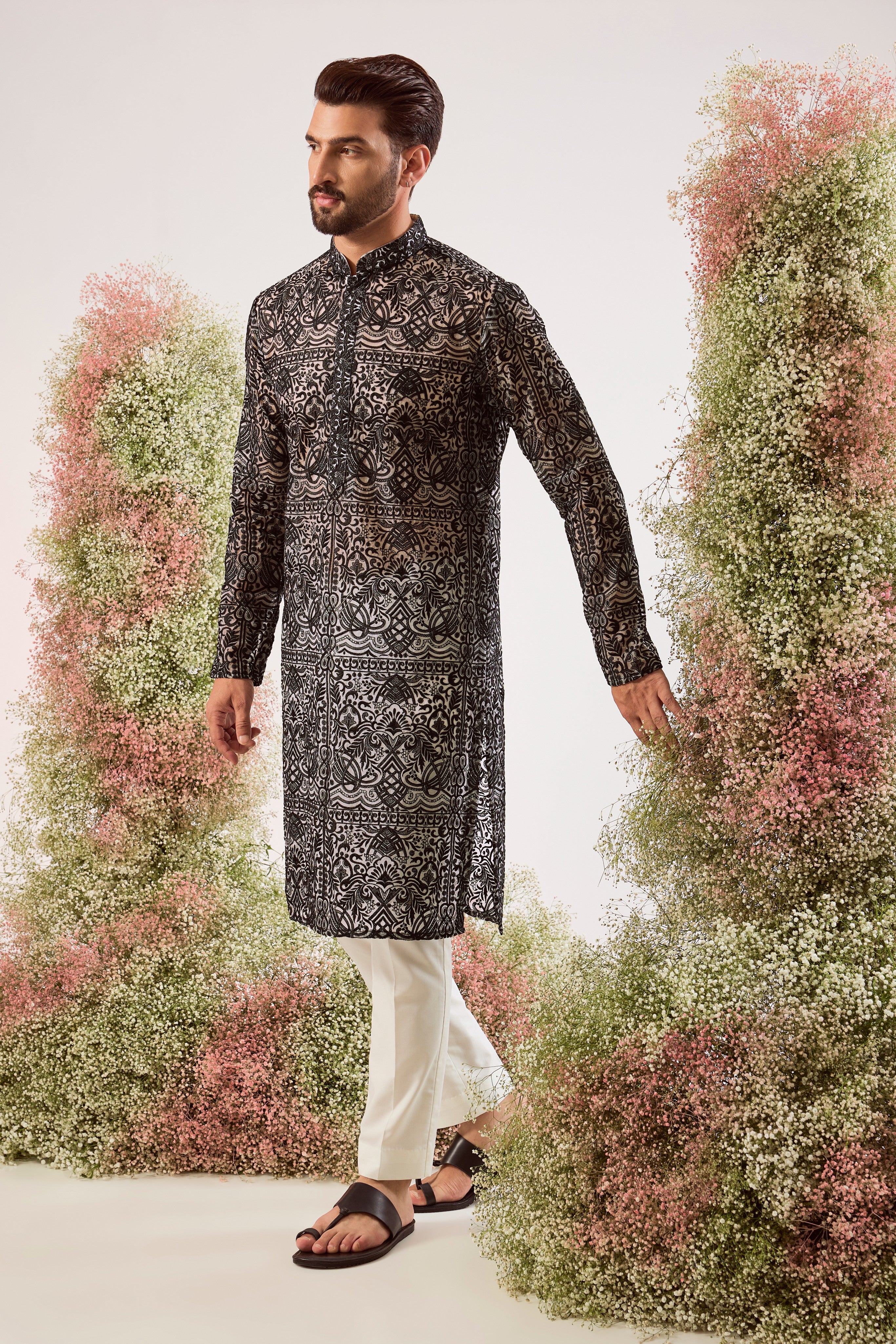 This striking black chikankari long see-through kurta is a masterpiece of modern elegance.