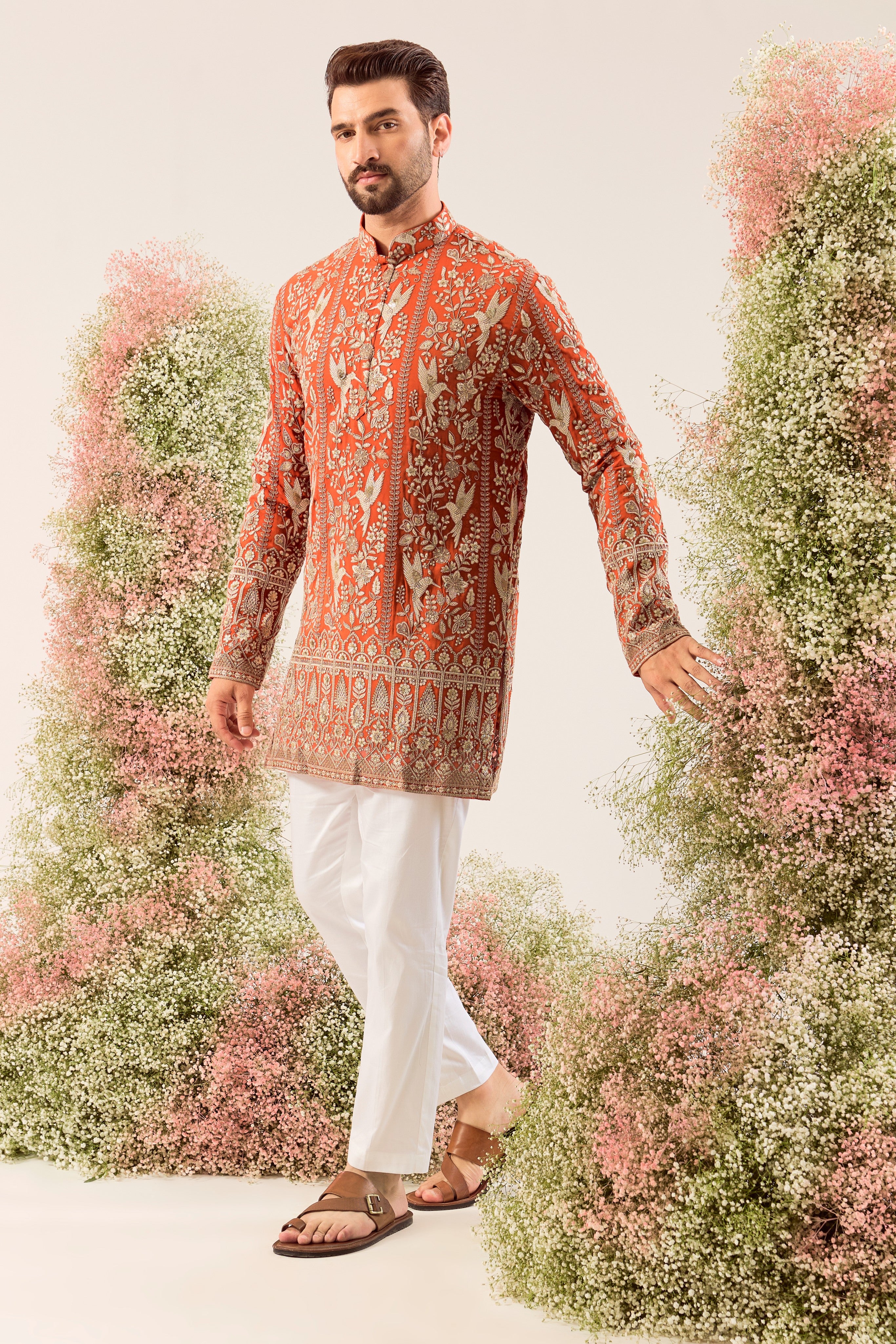This elegant orange short chikankari kurta is a masterpiece of modern artistry.