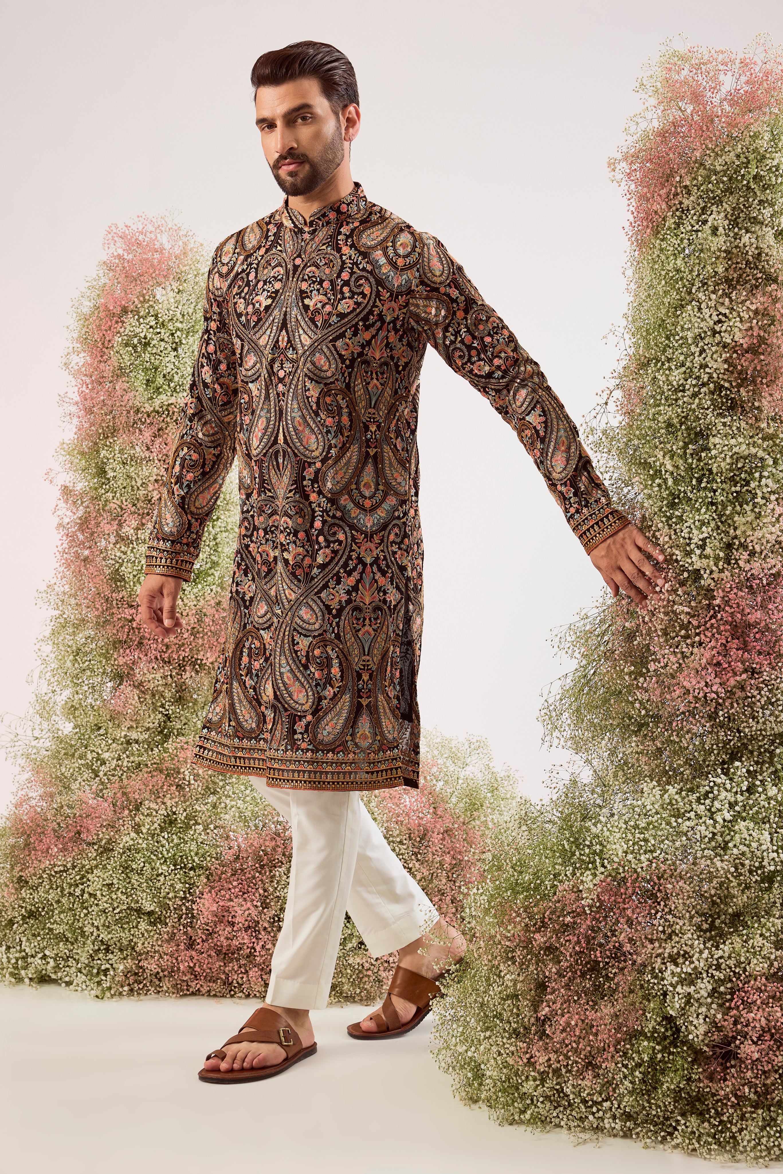 This striking black Kashmiri embroidered kurta is a masterpiece of traditional artistry.