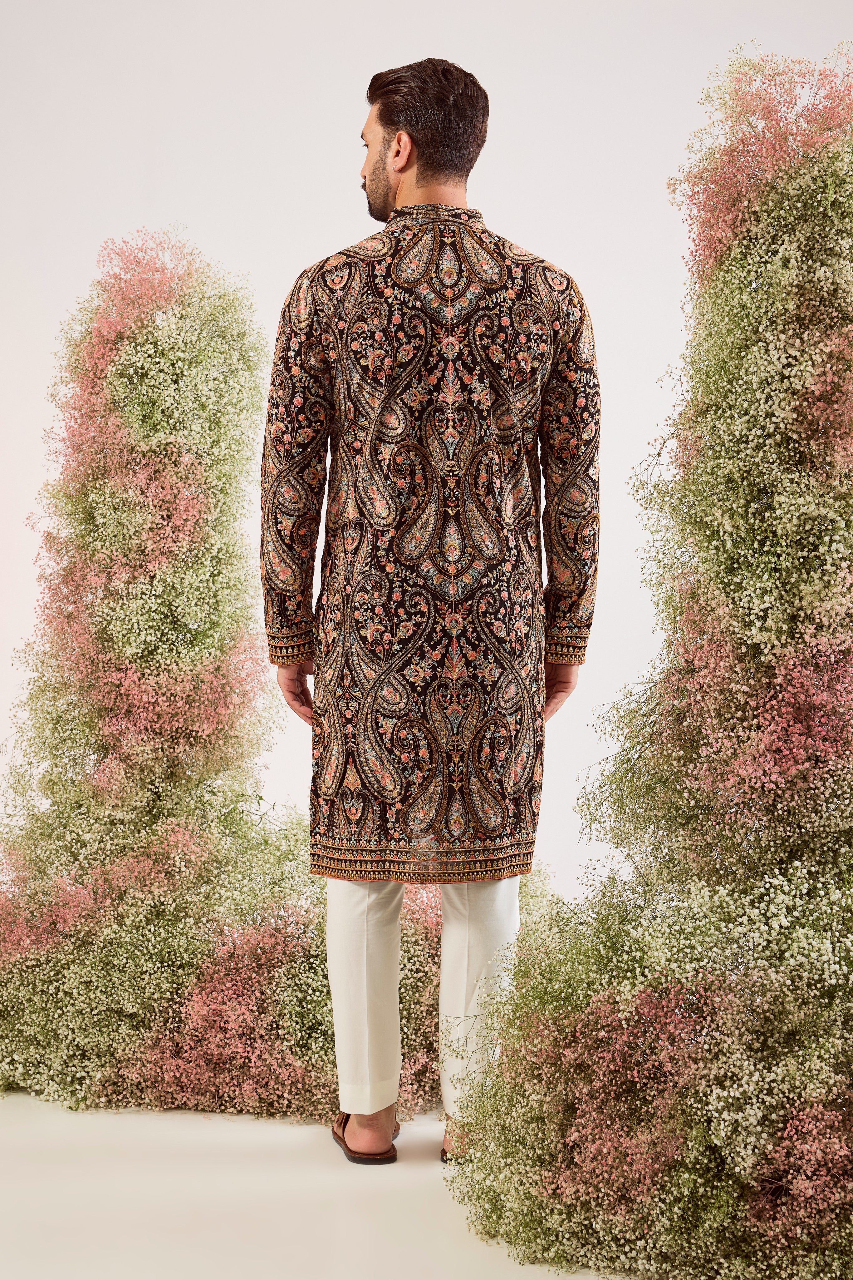 This striking black Kashmiri embroidered kurta is a masterpiece of traditional artistry.