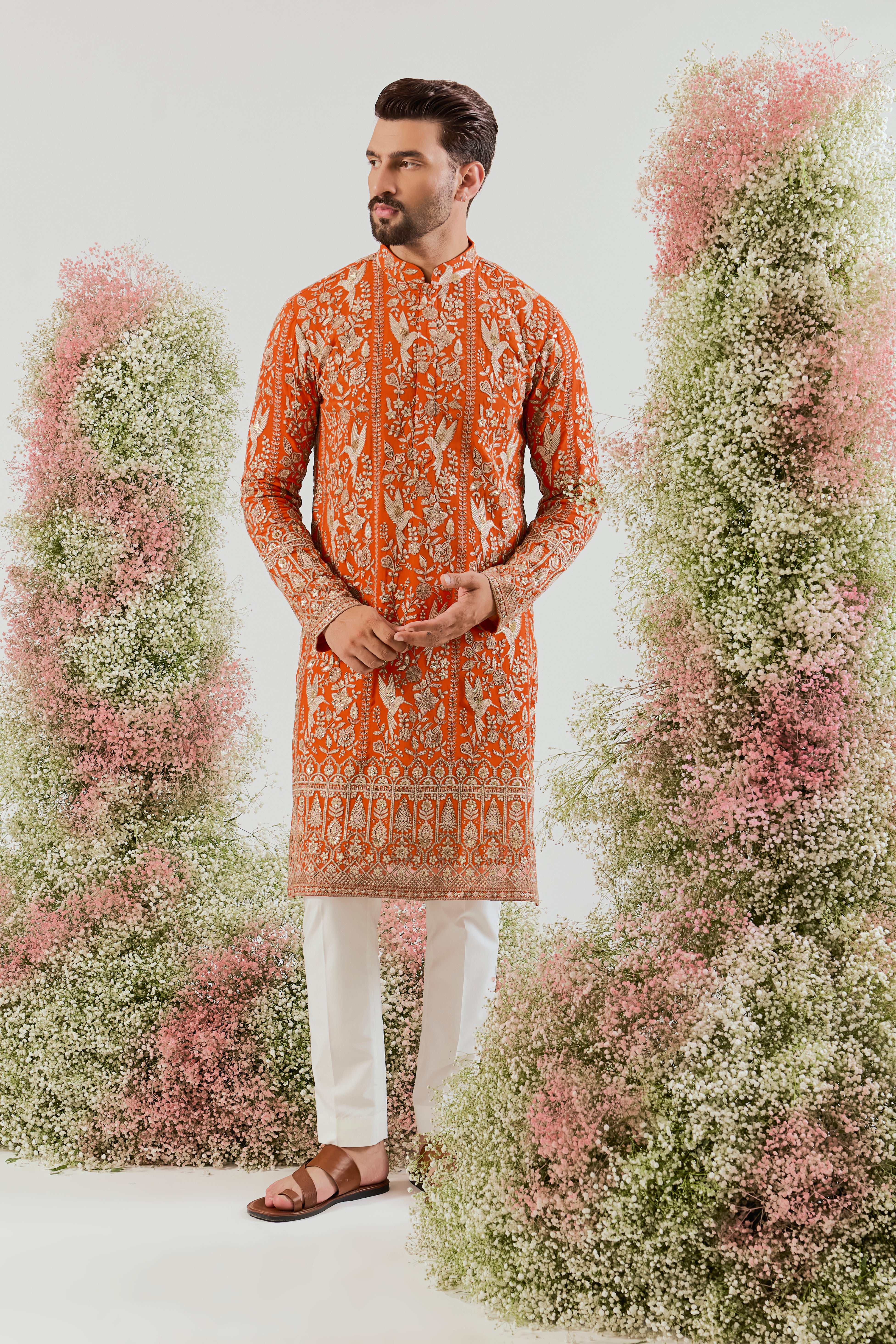 orange chikankari long kurta with intricate flora and fauna figures