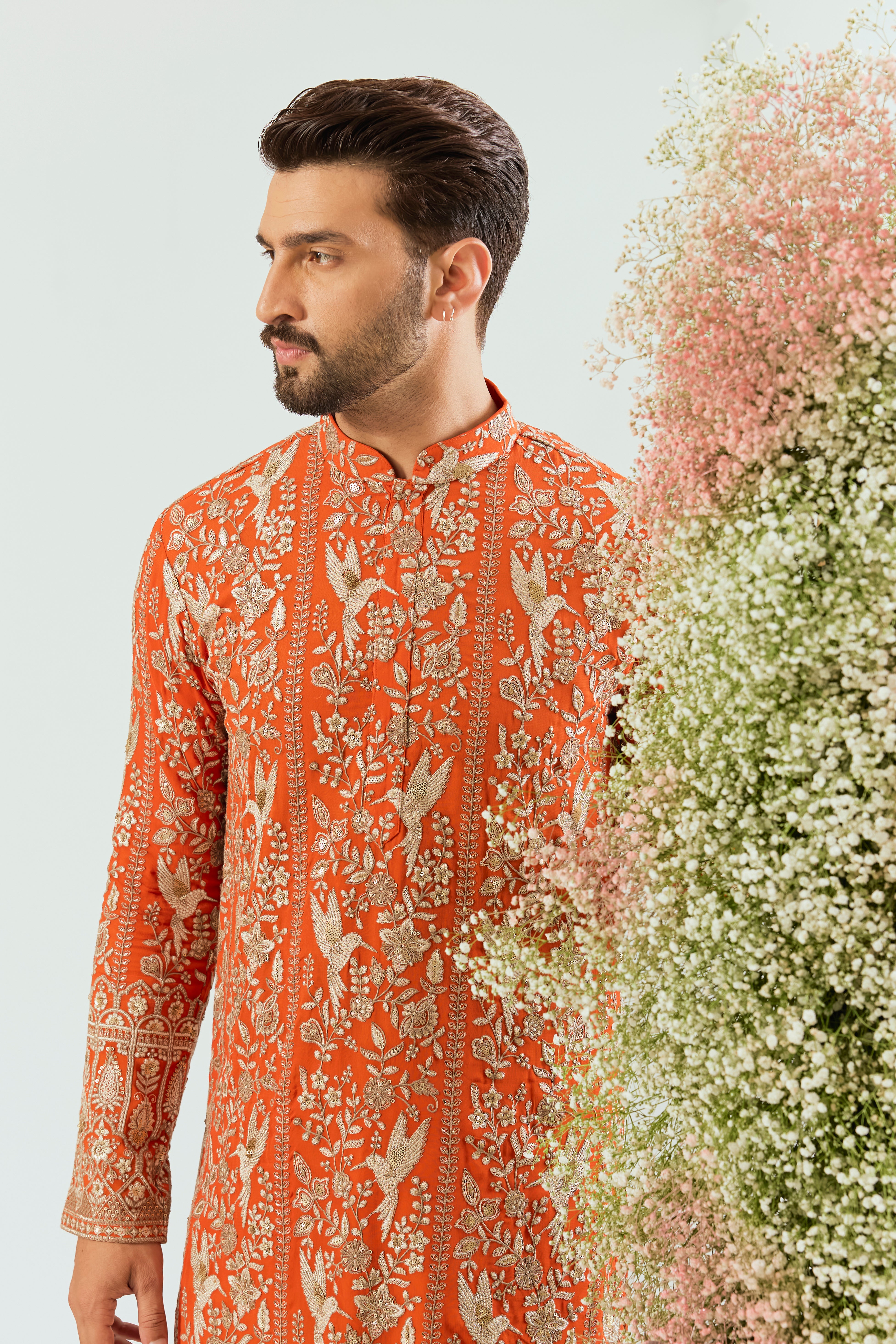 orange chikankari long kurta with intricate flora and fauna figures