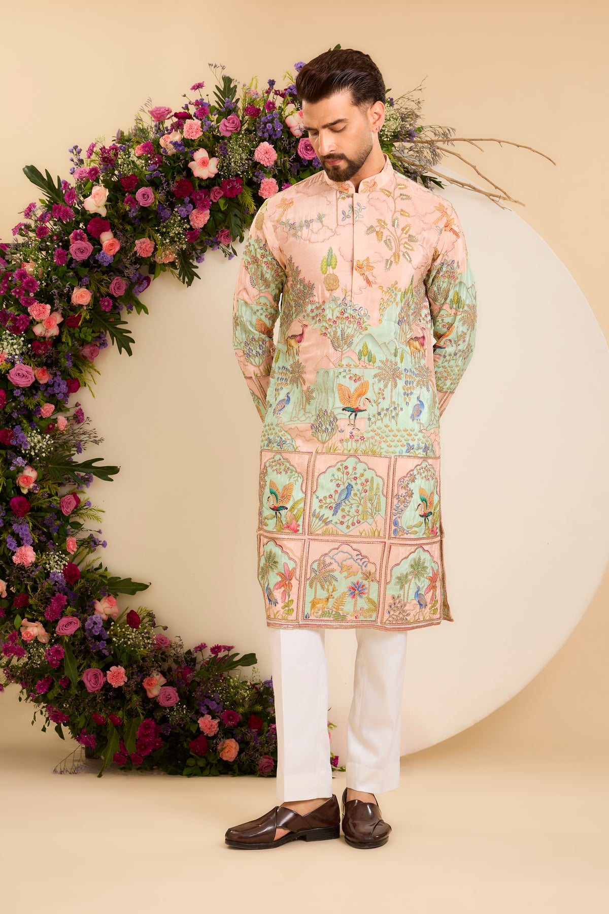 A Vibrant pink Crepe Kurta Richly Embroidered with Wildlife