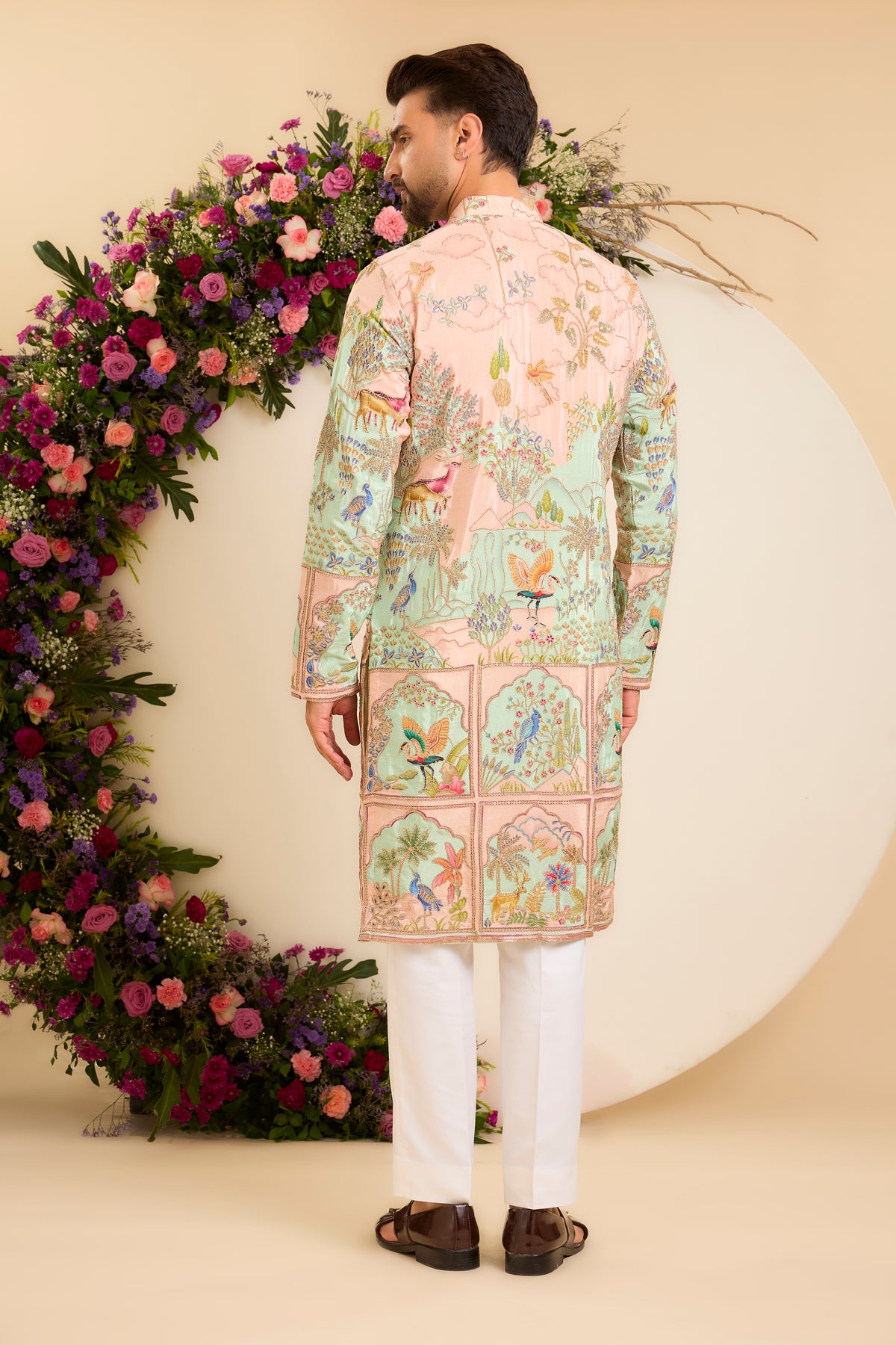 A Vibrant pink Crepe Kurta Richly Embroidered with Wildlife