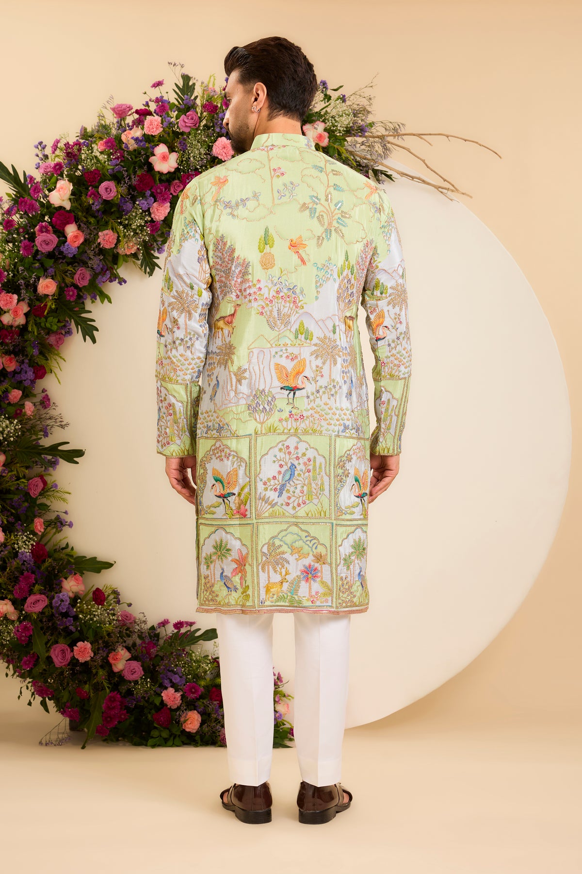 A Vibrant green Crepe Kurta Richly Embroidered with Wildlife